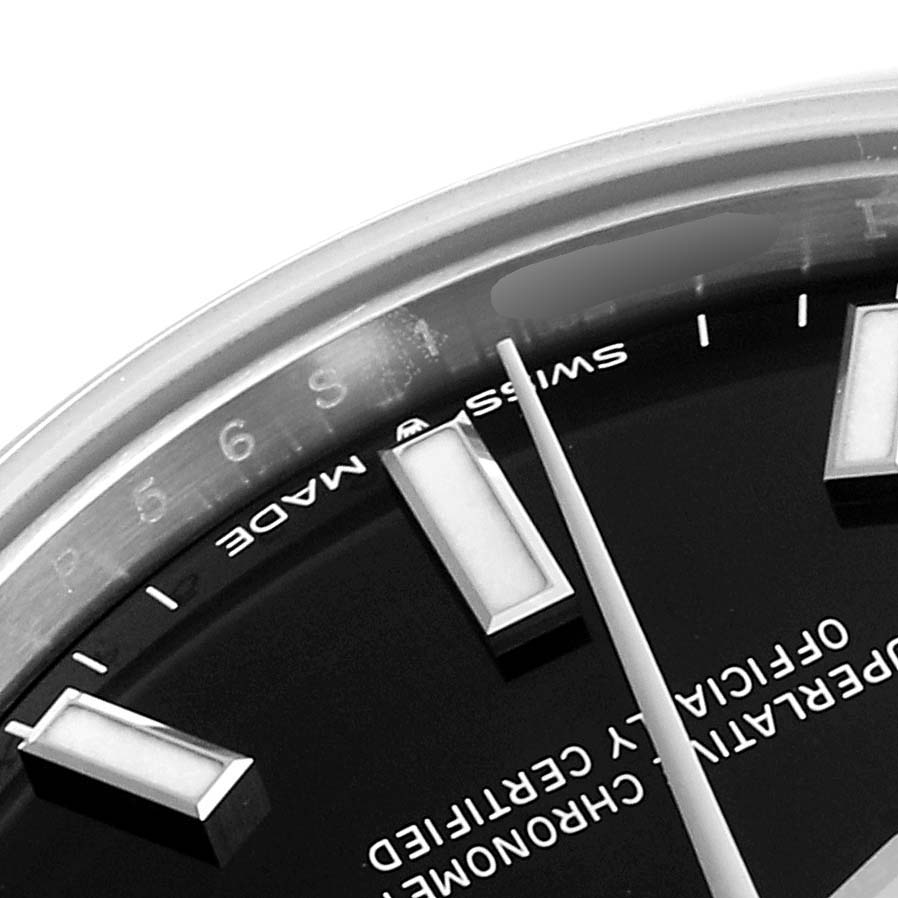 The image shows a close-up angle of the Rolex Mid-Size 277200 Women
s Stainless Steel Black Dial 277200 Women
s Stainless Steel Black Dial watch face, highlighting the hour markers, part of the bezel, and text details.
