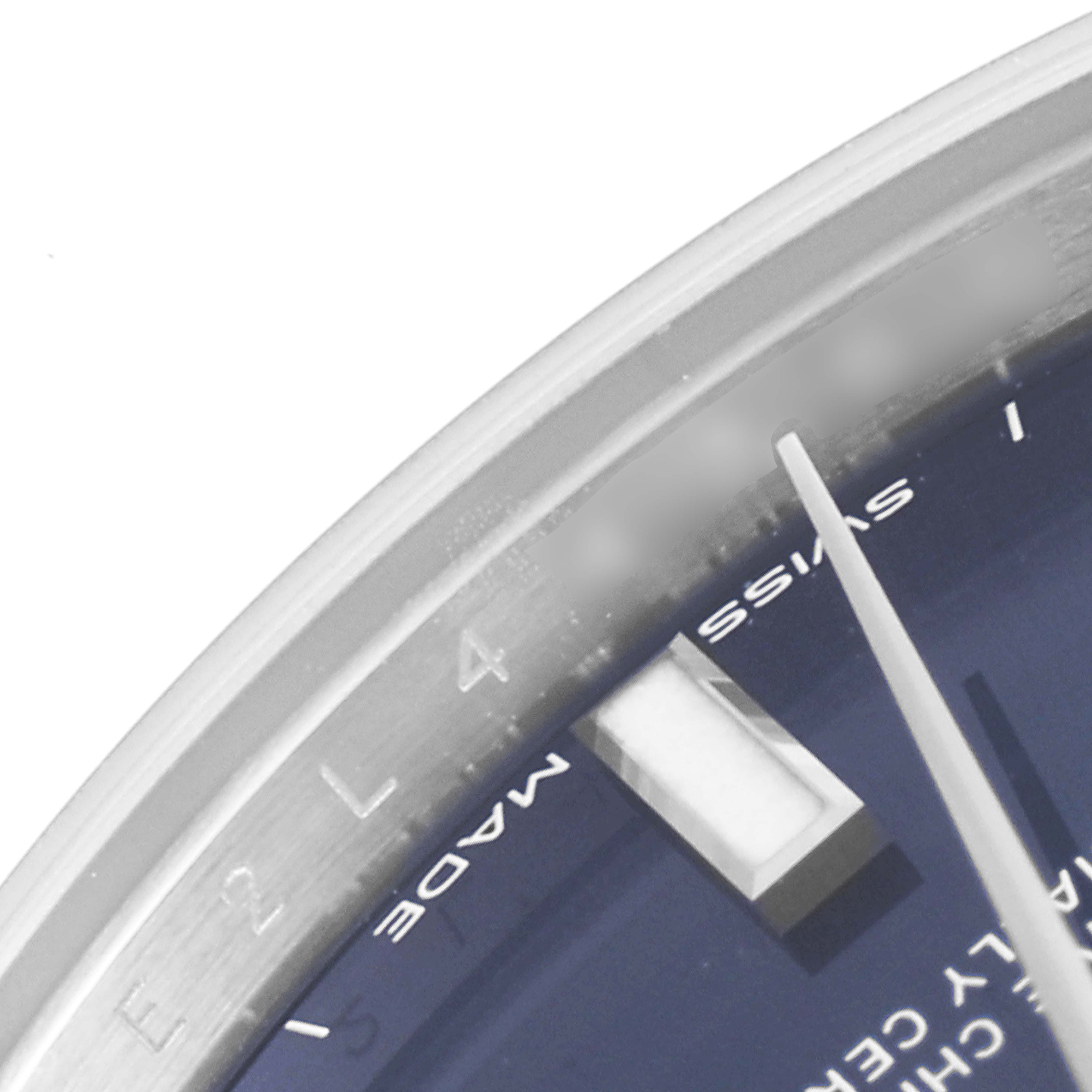 This image shows a close-up of the dial, hour marker, and part of the bezel of a Mid-Size Rolex watch.