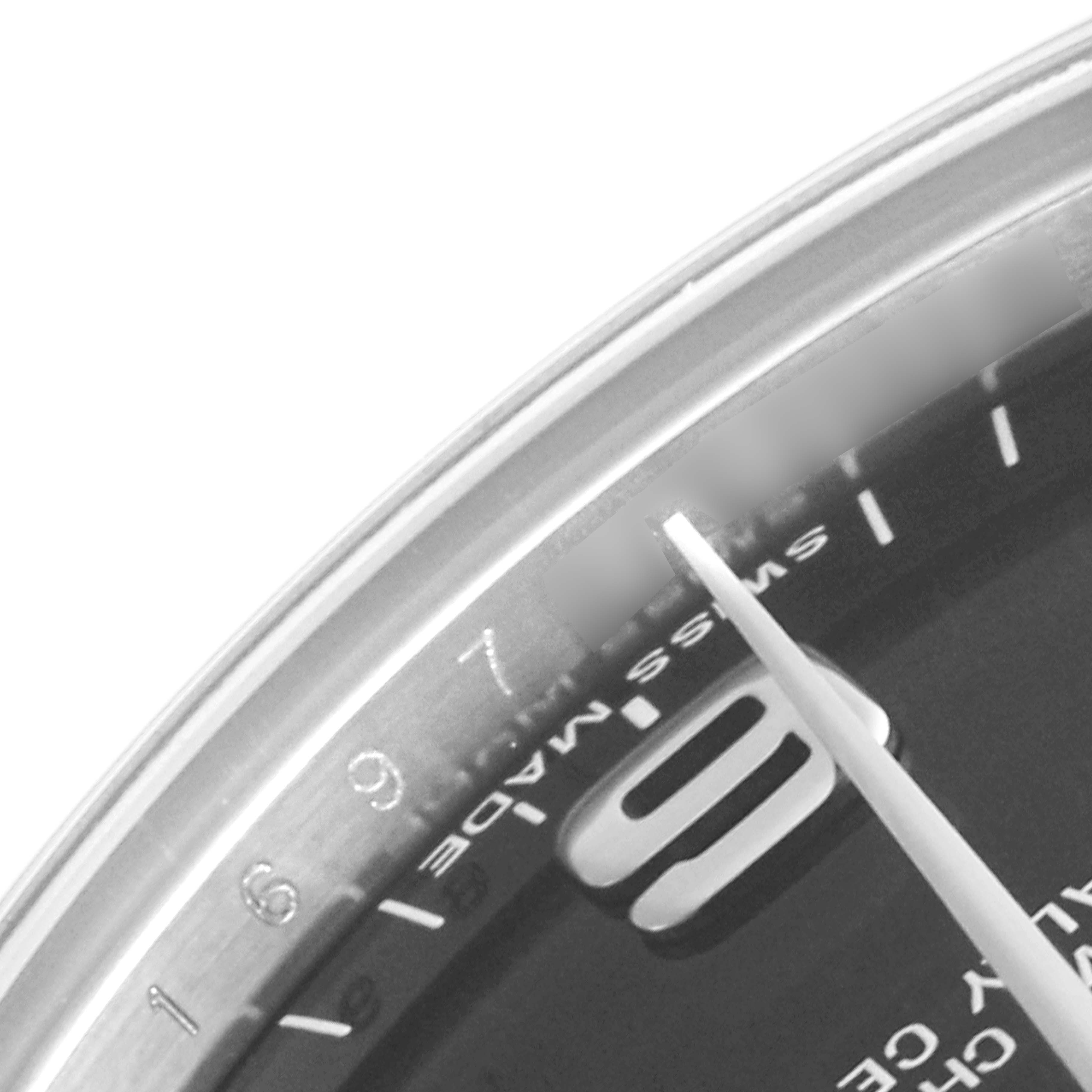 This close-up image of a Rolex Mid-Size 177200 Women's Stainless Steel Black Dial 177200 Women's Stainless Steel Black Dial model shows part of the watch dial with the "Swiss Made" marking and part of the hour and minute hands.