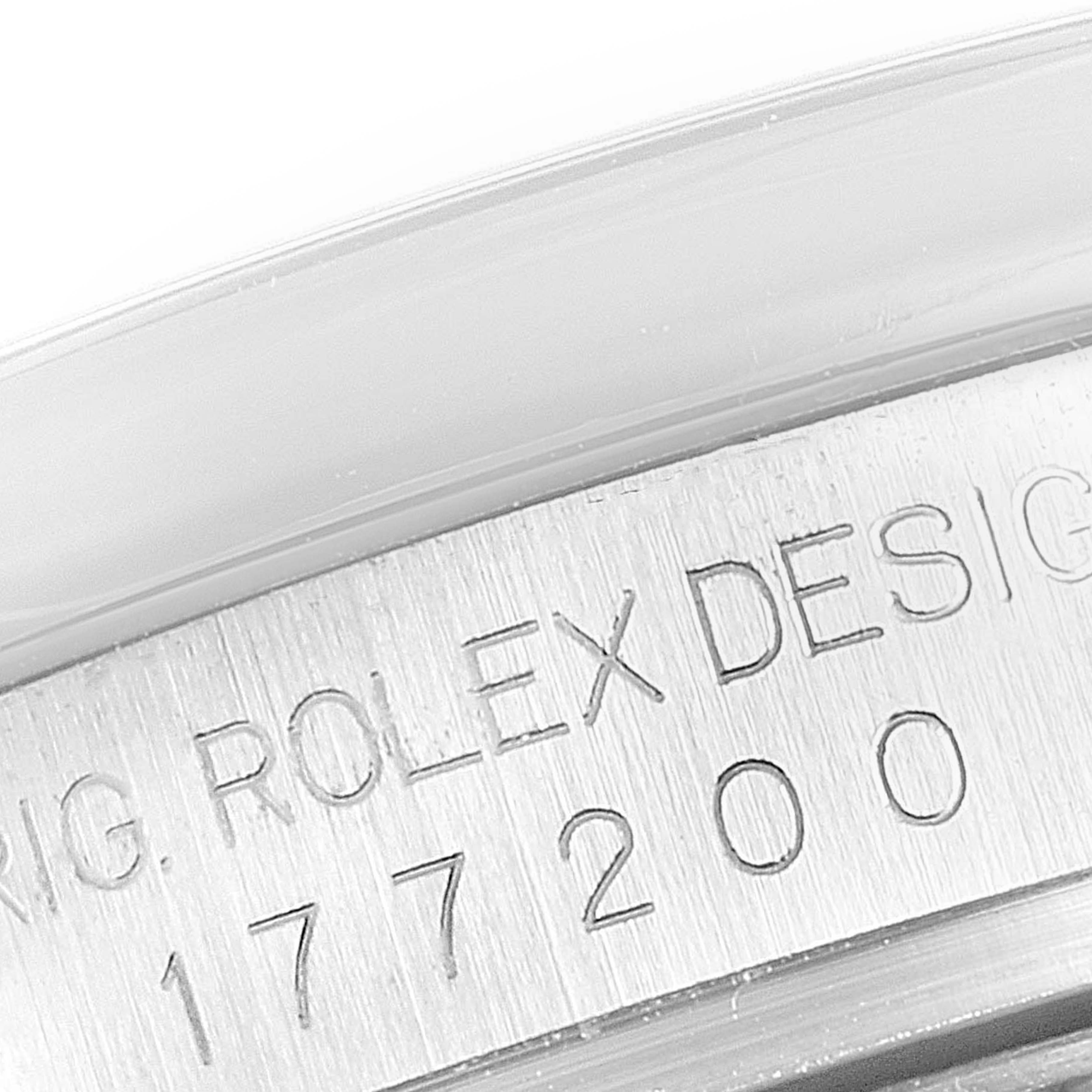 The image shows a close-up of the serial number engraving on the case of a Mid-Size Rolex watch.