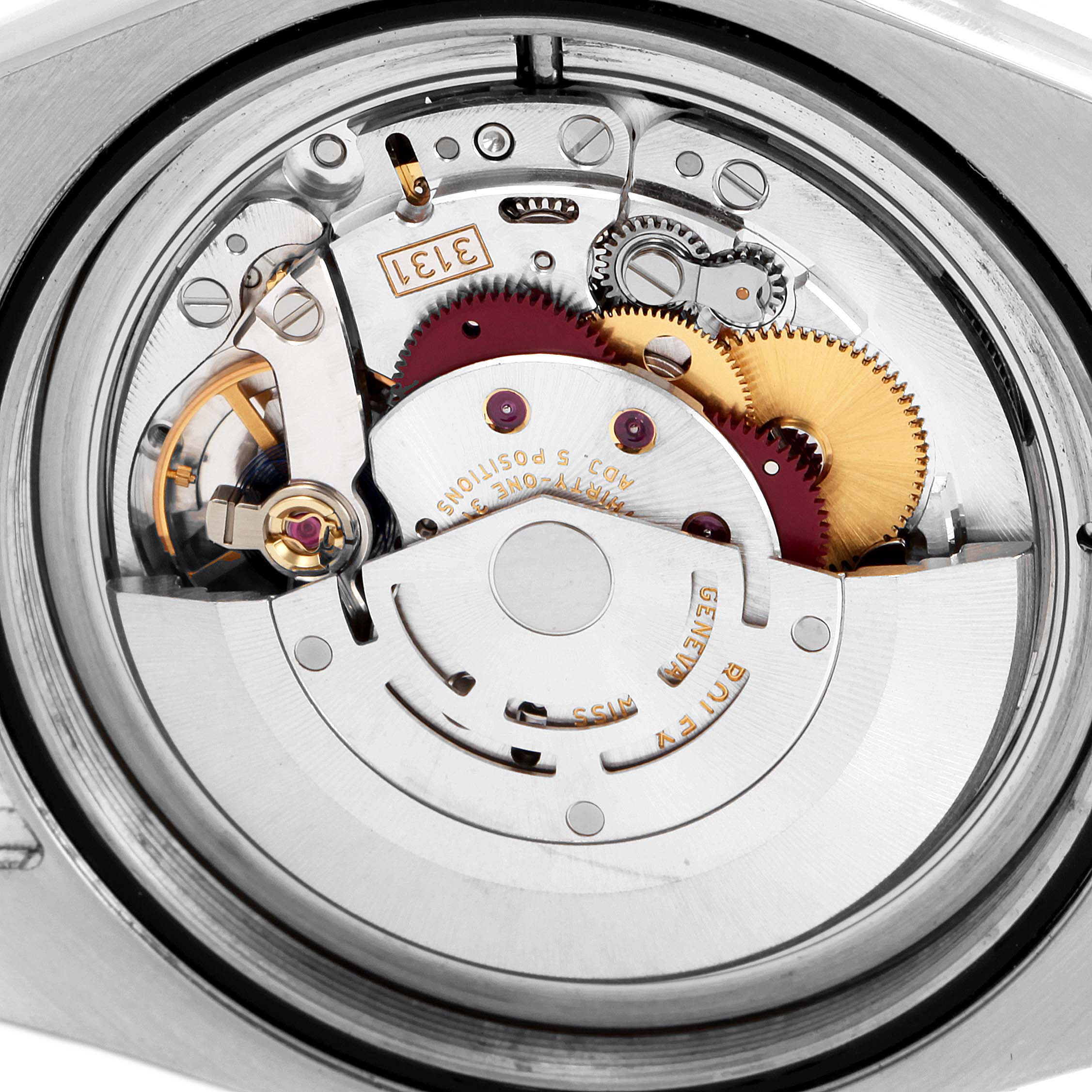 The image shows a close-up of the movement mechanism of a Rolex Milgauss 116400 Men's Stainless Steel White Dial 116400 Men's Stainless Steel White Dial watch, highlighting gears and intricate internal components.