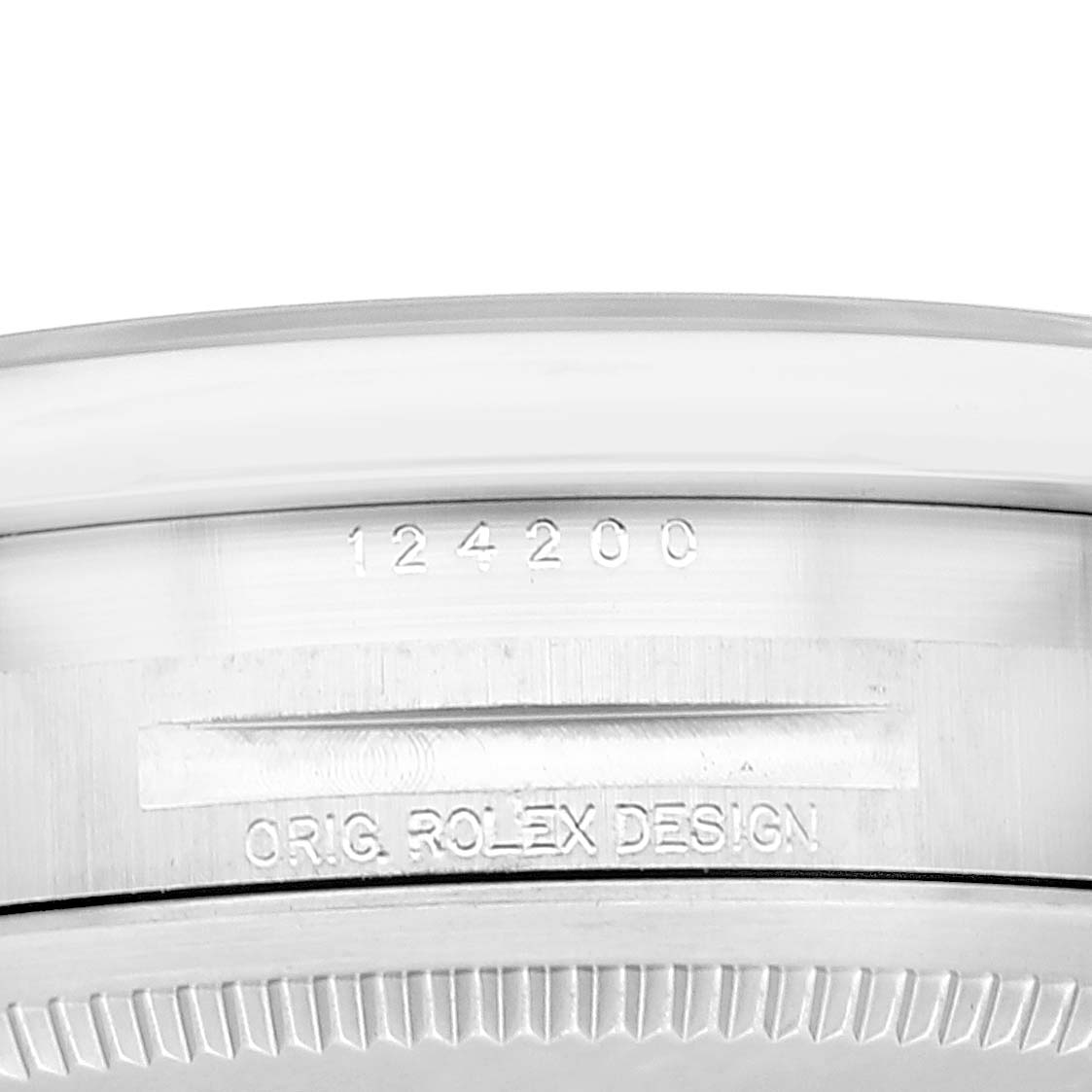 This image shows a close-up of the case side of the Oyster Perpetual Rolex watch, displaying its model number and design inscription.