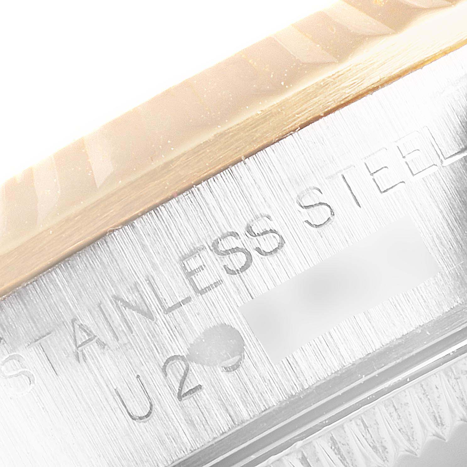 This close-up image shows part of the case and bezel of a Rolex Oyster Perpetual 67193 Women's Steel and Gold (two tone) Silver Dial 67193 Women's Steel and Gold (two tone) Silver Dial watch, highlighting the "Stainless Steel" engraving.