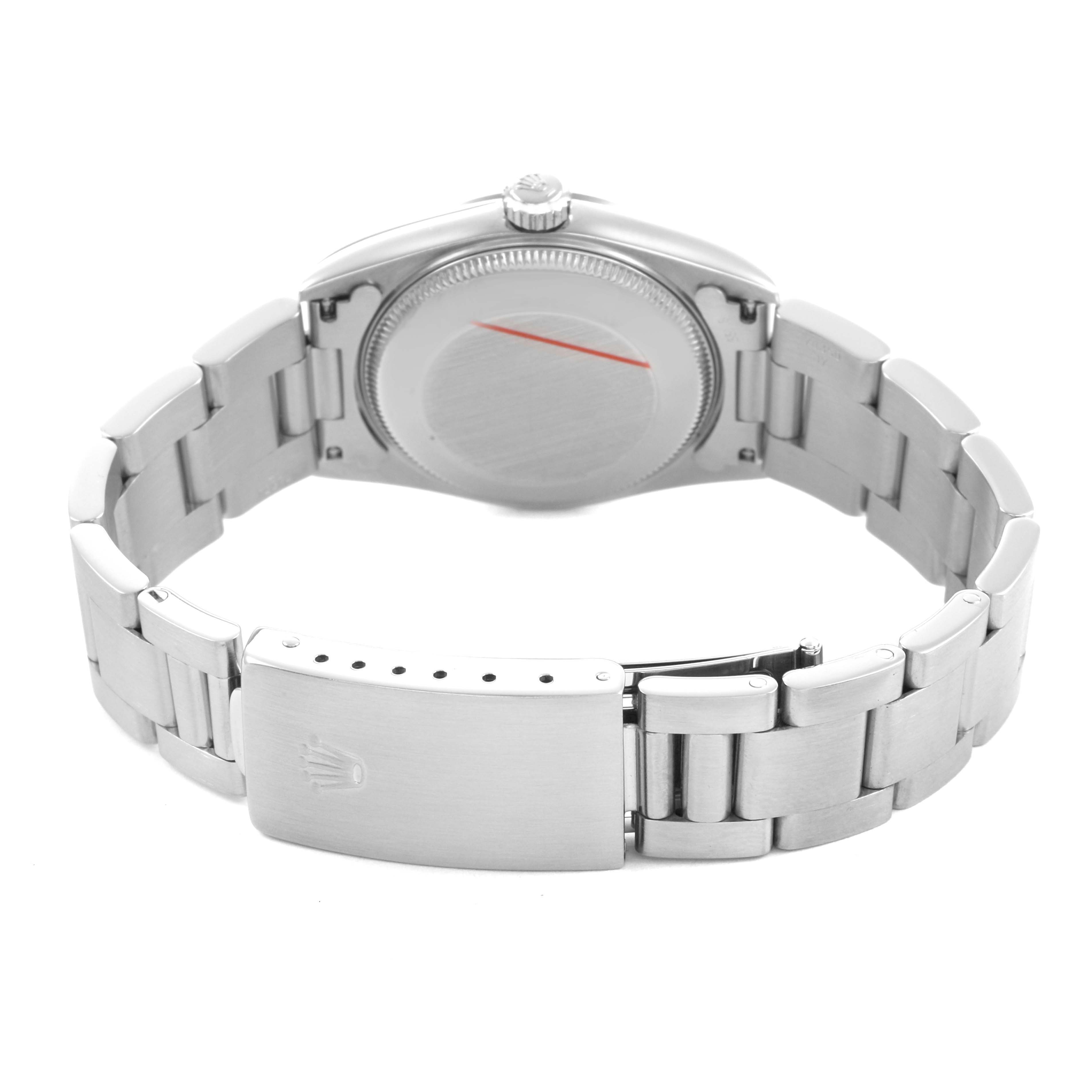 The image shows the backside of a Rolex Oyster Perpetual 77080 Women's Stainless Steel White Dial watch, highlighting the bracelet and clasp.