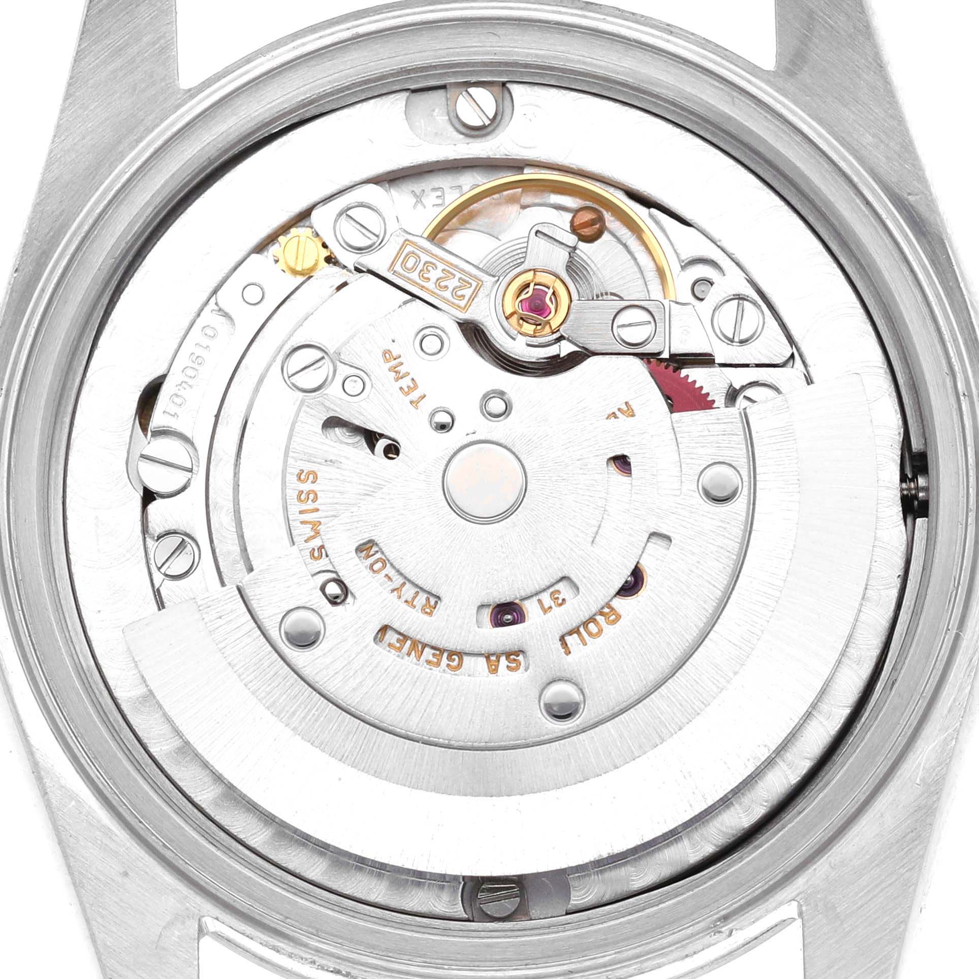 The image shows the inner movement mechanism of a Rolex Oyster Perpetual 77080 Women's Stainless Steel White Dial watch from the back.