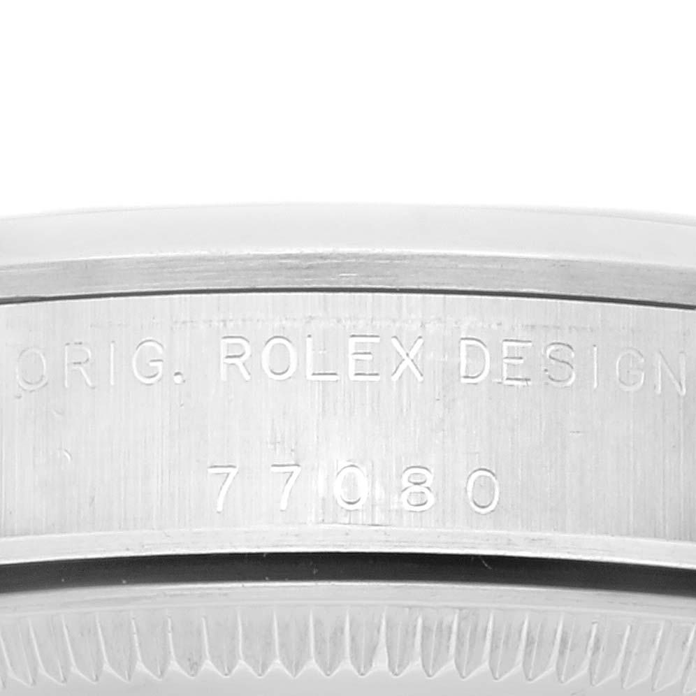 This image shows a close-up of the side of a Mid-Size Rolex watch with "ORIG. ROLEX DESIGN 77080" engraved.