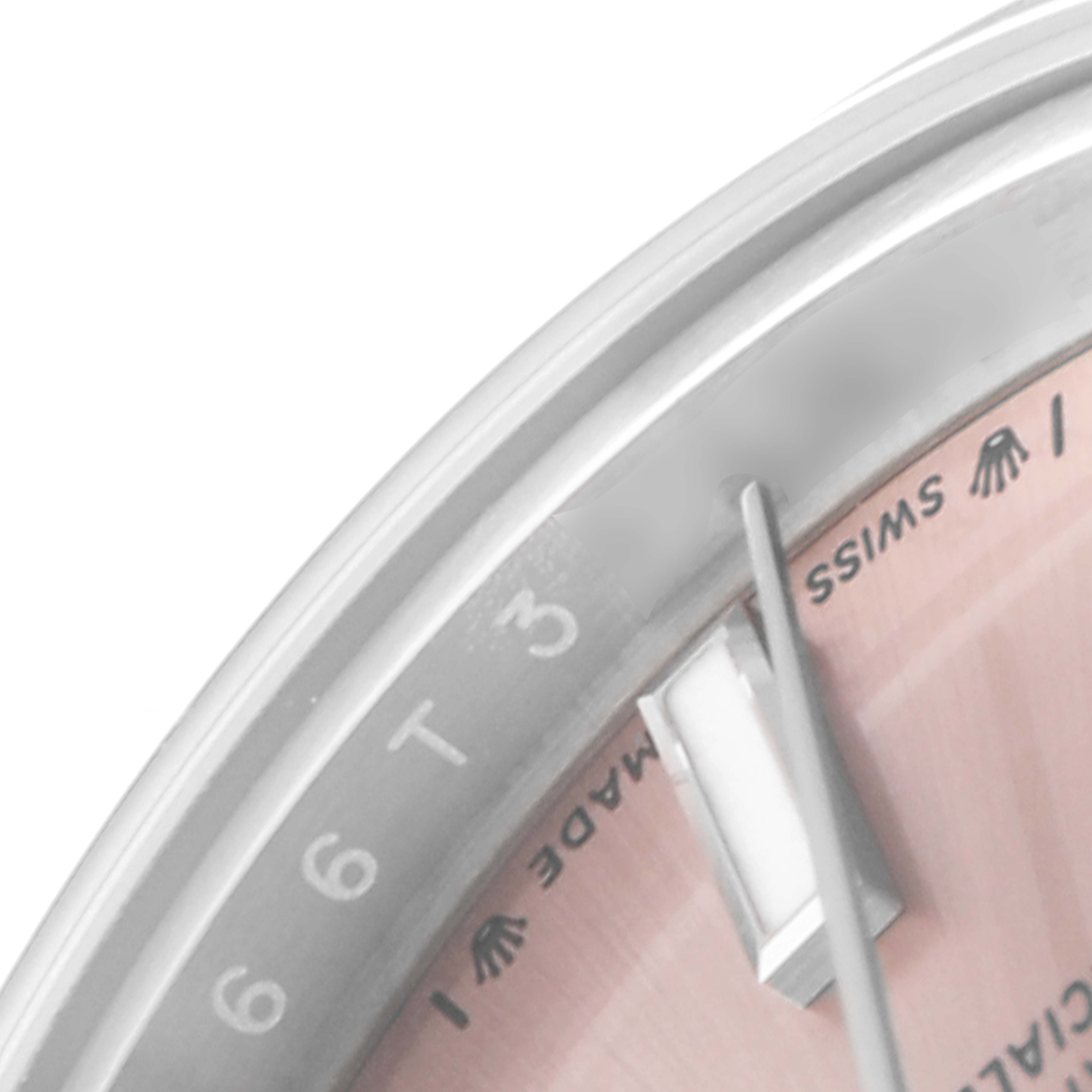 This close-up image of a Rolex Oyster Perpetual 276200 Women
s Stainless Steel Pink Dial 276200 Women
s Stainless Steel Pink Dial watch shows the bezel, part of the dial, and the "Swiss Made" inscription.