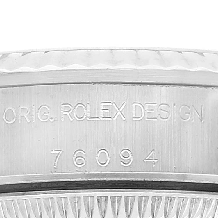 The image shows a close-up view of the engravings on the side of the bezel of a Rolex Oyster Perpetual 76094 Women's Stainless Steel Black Dial 76094 Women's Stainless Steel Black Dial watch.