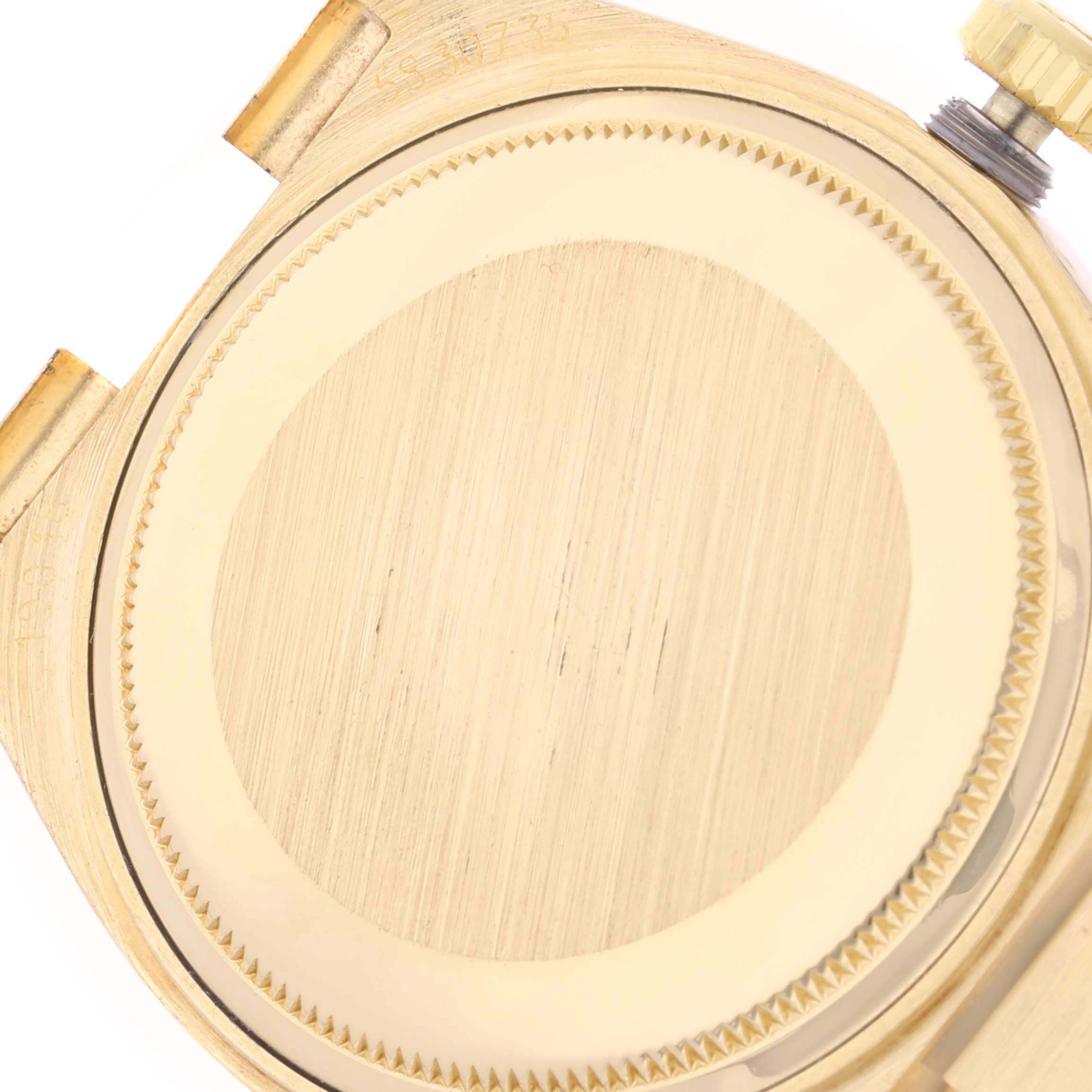 This image shows the case back and crown of a Rolex Oysterquartz 19018 Men
s Yellow Gold Champagne Dial 19018 Men
s Yellow Gold Champagne Dial watch from an overhead angle.