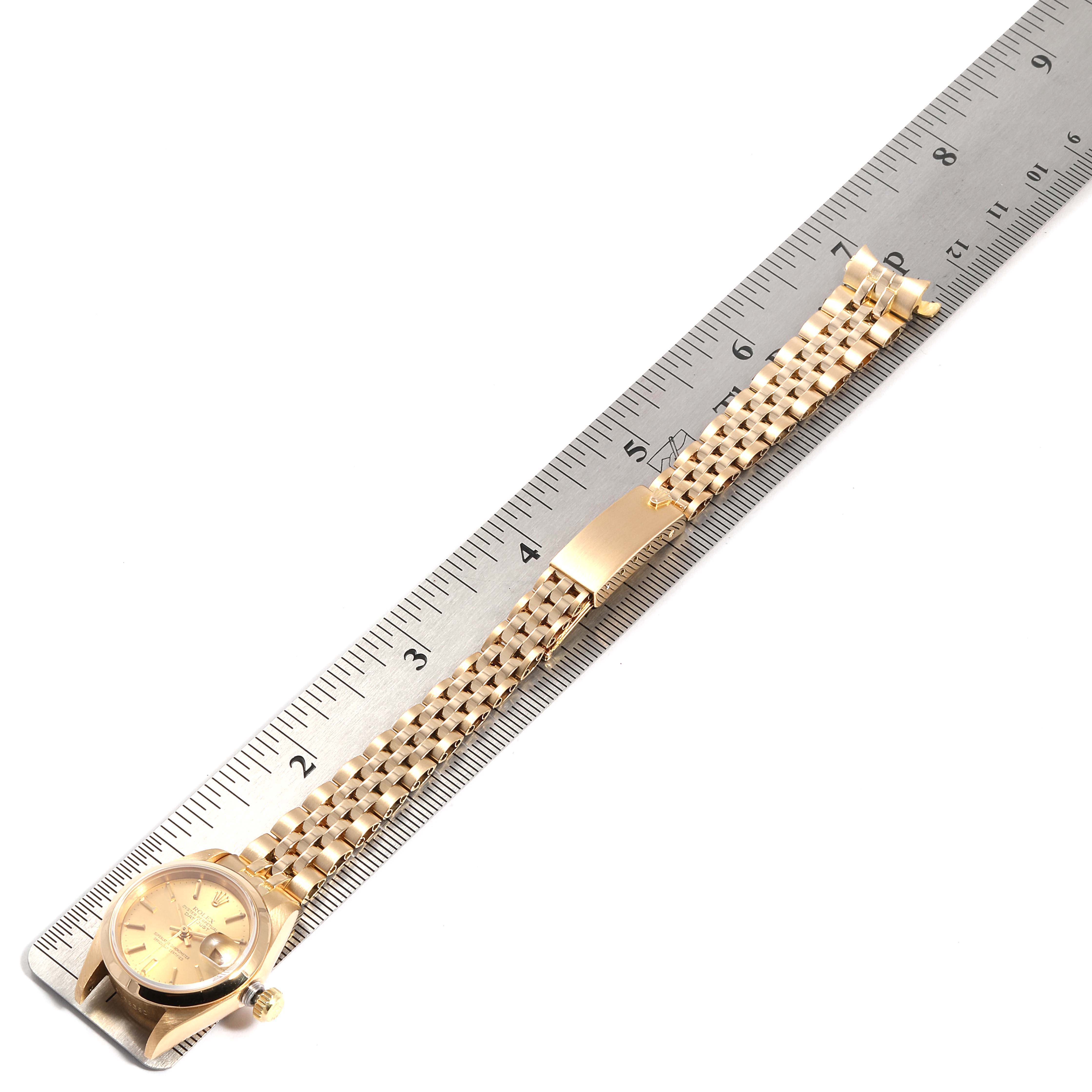 The image shows a Rolex President 69168 Women's Yellow Gold  69168 Women's Yellow Gold  model watch displayed from a bird's-eye view with its bracelet extended and positioned alongside a ruler.