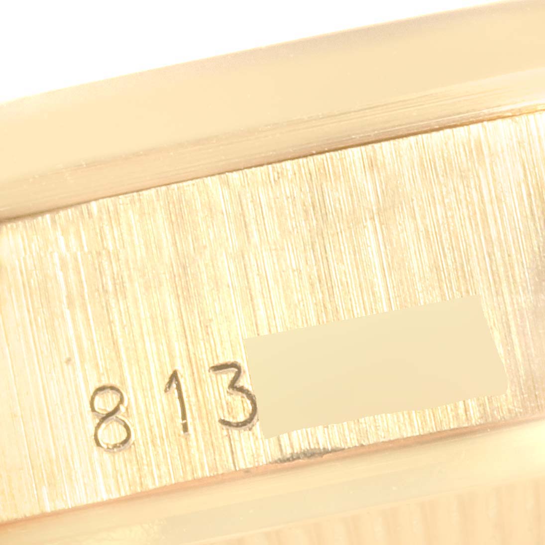 The image shows a close-up view of the case side of a Rolex President 69168 Women's Yellow Gold  69168 Women's Yellow Gold  watch, revealing part of its serial number.