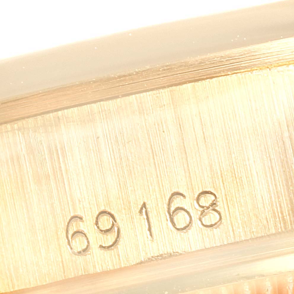 This close-up image shows the case back edge with the serial number for a Rolex President 69168 Women's Yellow Gold  69168 Women's Yellow Gold  model watch.