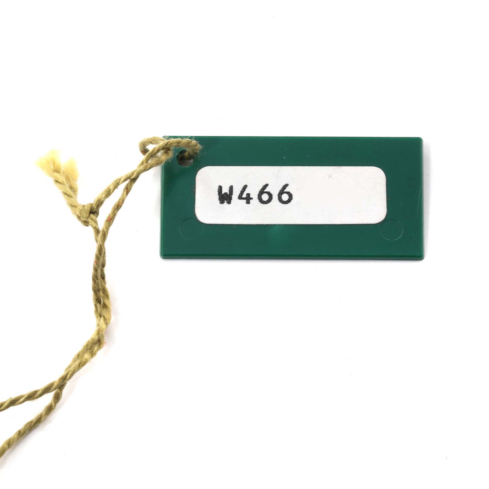 This image shows a green tag with a yellow string, likely accompanying the Rolex President 69288 Women's Yellow Gold Champagne Dial 69288 Women's Yellow Gold Champagne Dial model.