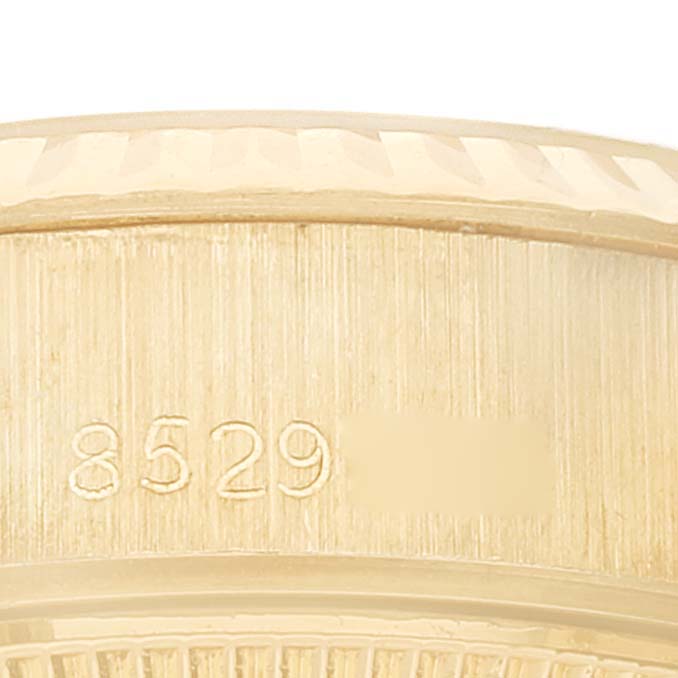 This close-up image shows the engraved side of the bezel of a Rolex President 69178 Women's Yellow Gold Champagne Dial 69178 Women's Yellow Gold Champagne Dial model watch.