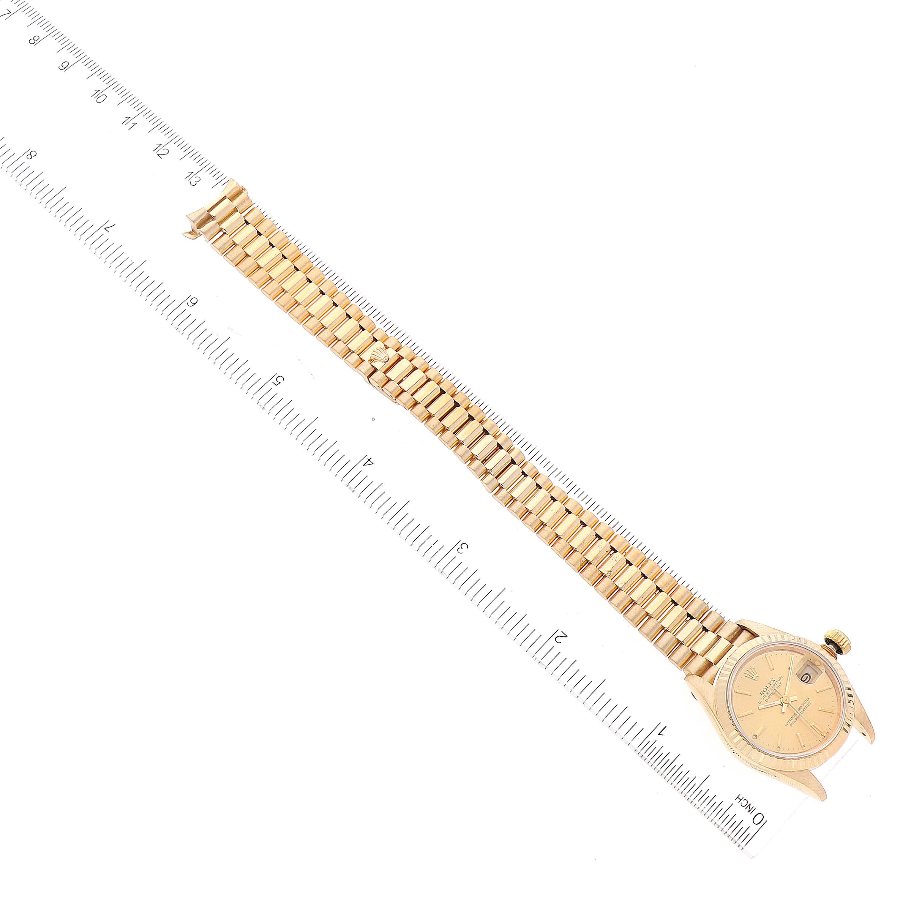 The image shows a Rolex President 69178 Women's Yellow Gold Champagne Dial 69178 Women's Yellow Gold Champagne Dial watch laid flat, featuring the watch face, bracelet, and crown in a top-down view next to a ruler.