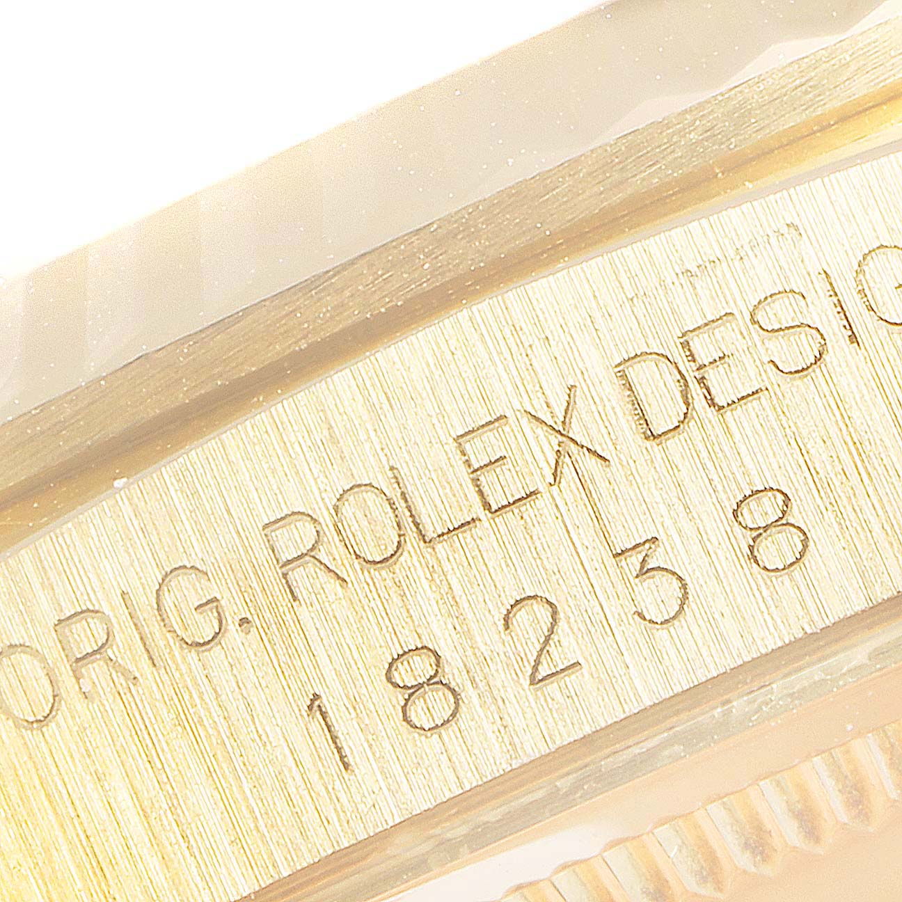 The image shows a close-up of the inscribed model number and design details on the case of a Rolex President 18238 Men
s Yellow Gold Champagne Dial 18238 Men
s Yellow Gold Champagne Dial model 18238.