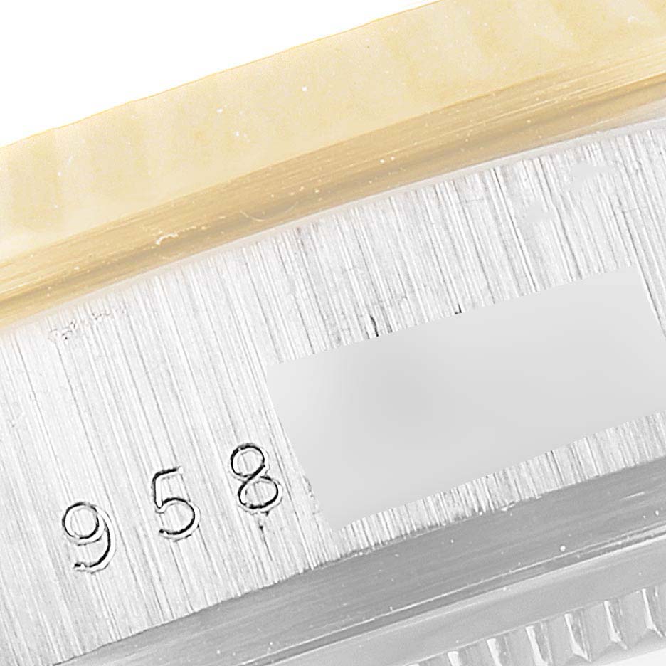 This close-up shows the case engraving and part of the fluted bezel on a Rolex President 18039B Men's White Gold Brown Dial 18039B Men's White Gold Brown Dial model watch.