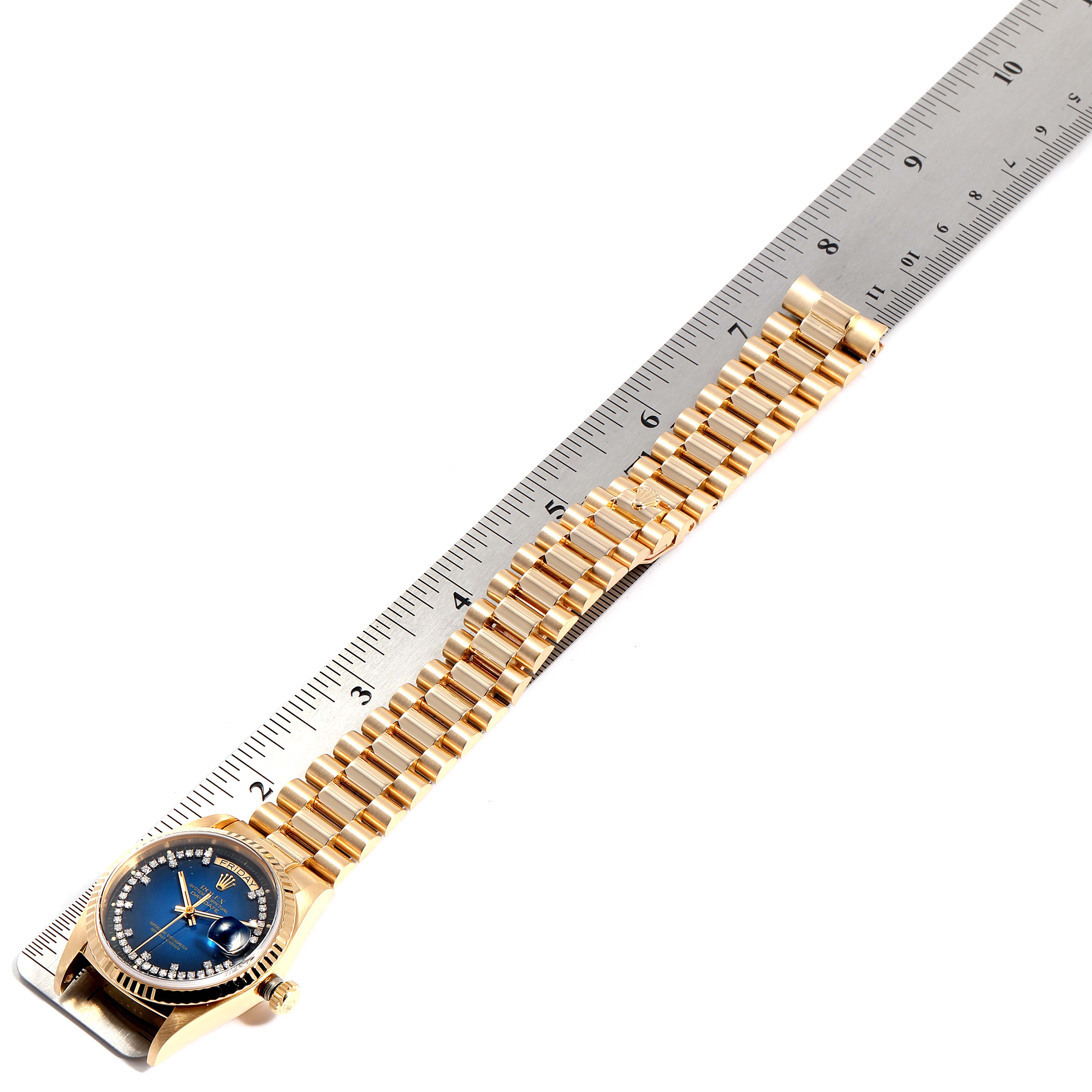 The image shows a Rolex President 18038 Men's Yellow Gold Blue Dial 18038 Men's Yellow Gold Blue Dial model watch with a gold bracelet, displayed next to a measuring ruler.