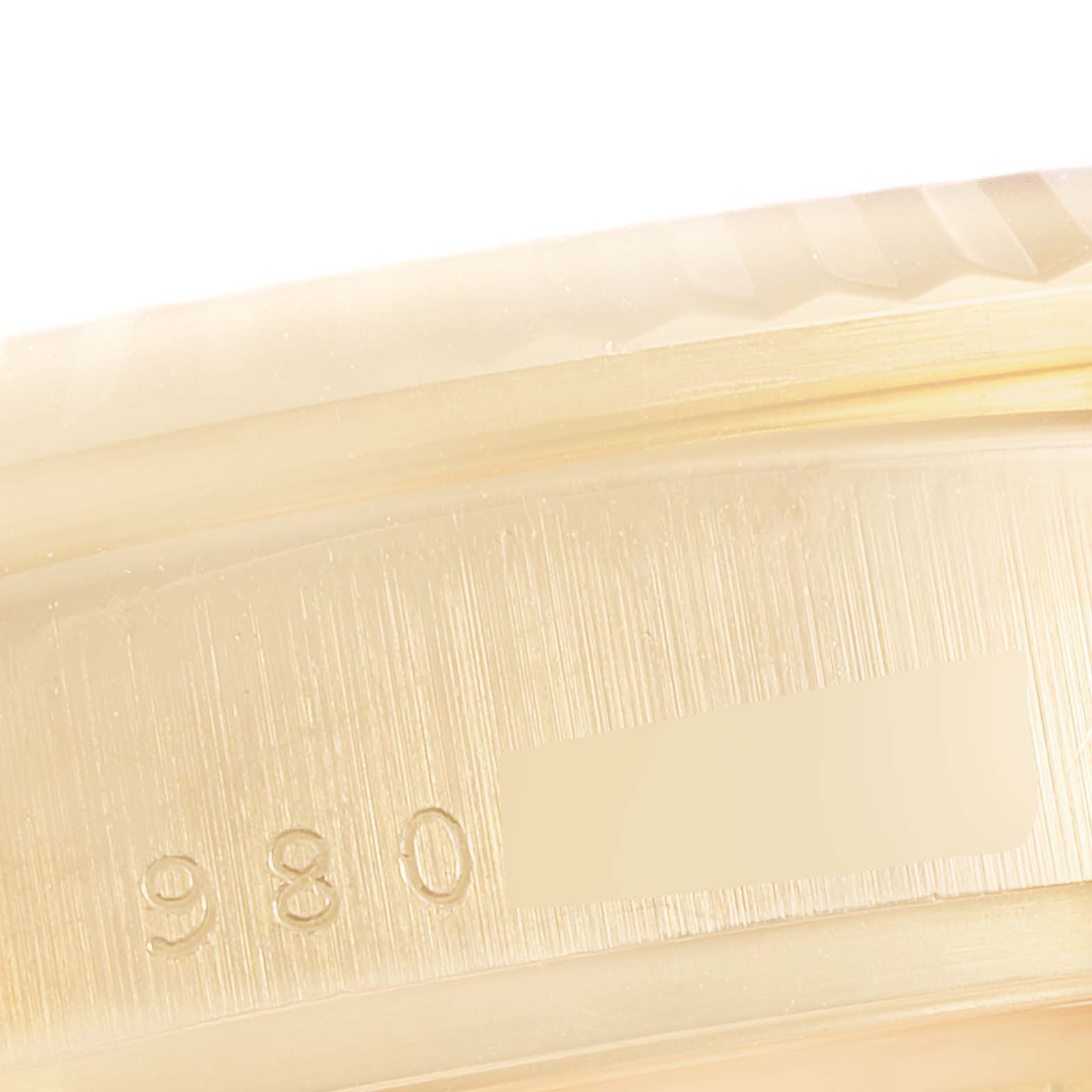 This image shows a close-up of the side of a Rolex President 18038 Men's Yellow Gold Blue Dial 18038 Men's Yellow Gold Blue Dial model watch, highlighting a serial number.