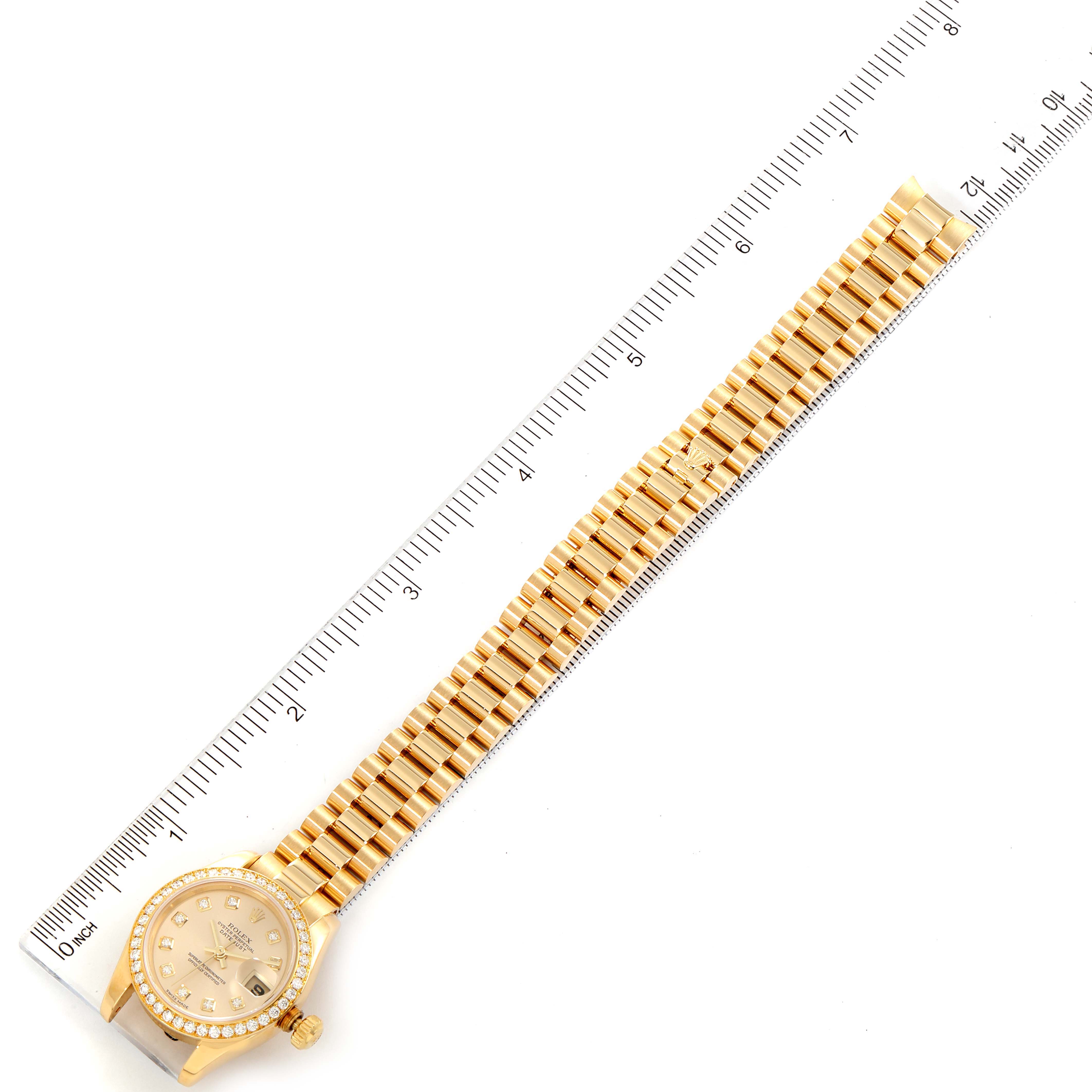The photo shows a Rolex President 179138 Women
s Yellow Gold Champagne Dial 179138 Women
s Yellow Gold Champagne Dial model watch laid flat with a ruler measuring its length.