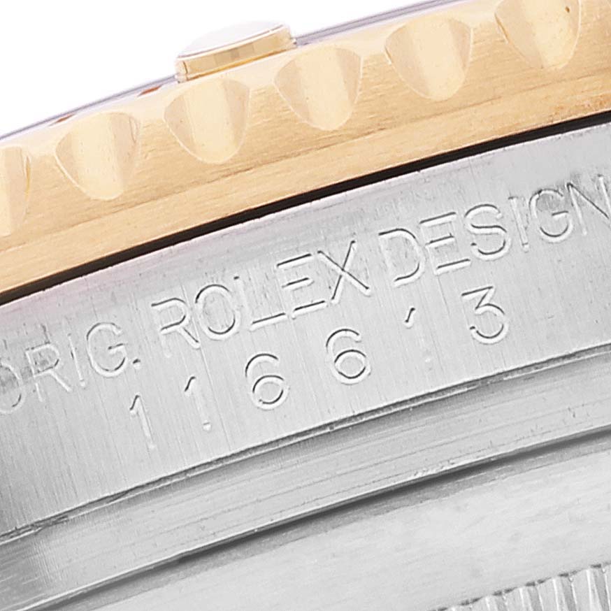 The image shows a close-up of the side of a Rolex Submariner 116613 Men's Steel and Gold (two tone) Blue Dial 116613 Men's Steel and Gold (two tone) Blue Dial watch, highlighting the engraved model number and part of the bezel.