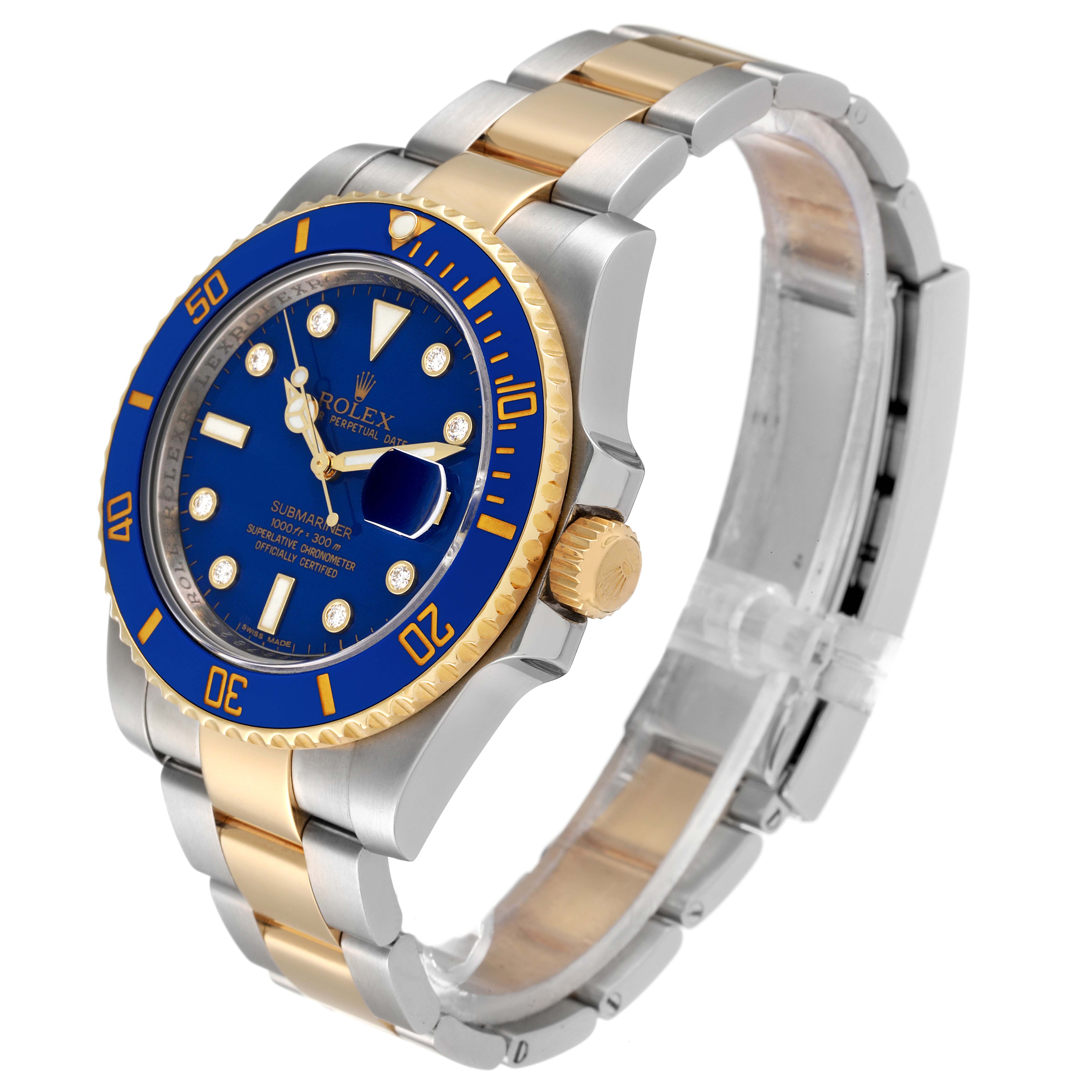 The image shows a Rolex Submariner 116613 Men's Steel and Gold (two tone) Blue Dial 116613 Men's Steel and Gold (two tone) Blue Dial watch with a blue bezel, blue dial, and two-tone gold and silver bracelet at an angle highlighting the watch face and crown.
