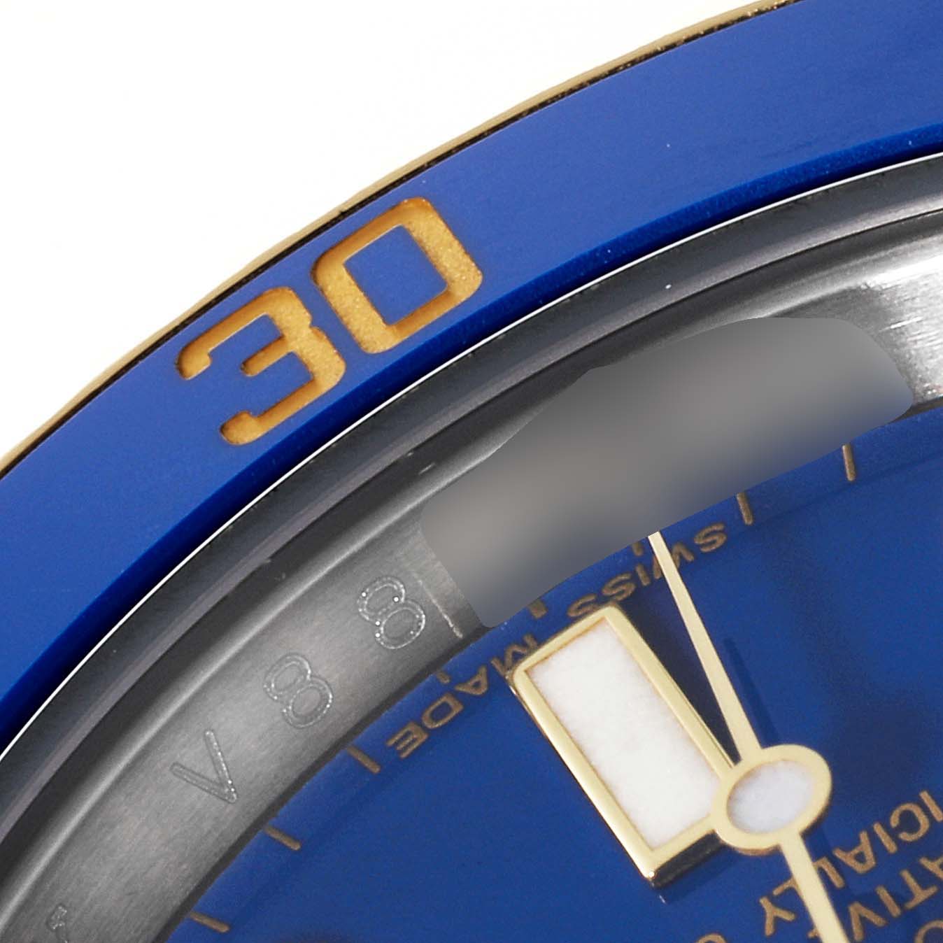 This close-up image of a Rolex Submariner 116613 Men's Steel and Gold (two tone) Blue Dial 116613 Men's Steel and Gold (two tone) Blue Dial watch shows part of the blue bezel, dial, and hour hand.