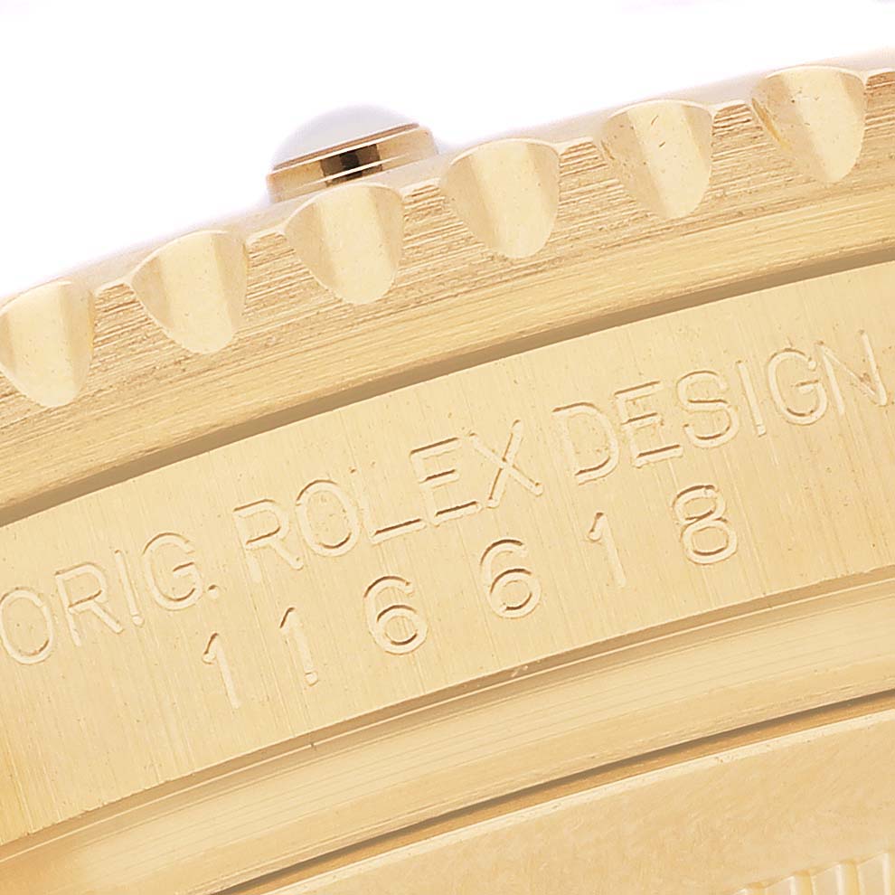 The angle shows a close-up of the bezel and case edge of a Rolex Submariner 116618 Men's Yellow Gold Blue Dial, displaying the model number and engraving details.