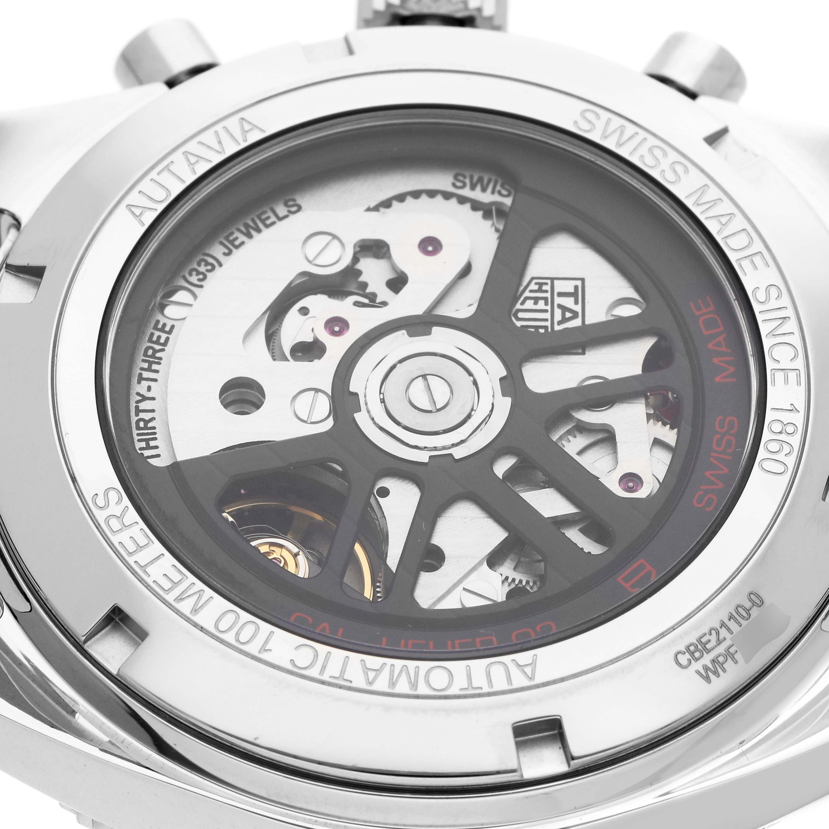 The image shows the back of a Tag Heuer Autavia CBE2110 Men
s Stainless Steel Black Dial watch, displaying the movement and engravings through the transparent case back.