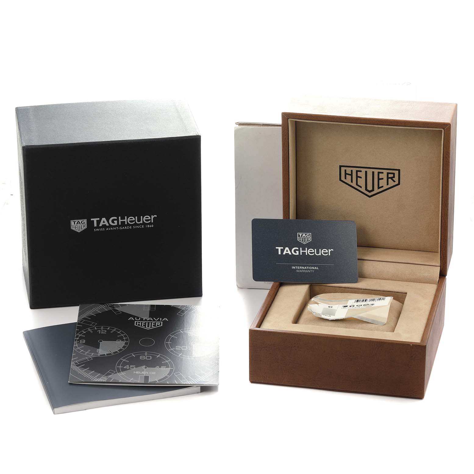 The image shows the packaging of the TAG Heuer Autavia model, including the box, warranty card, and manuals.