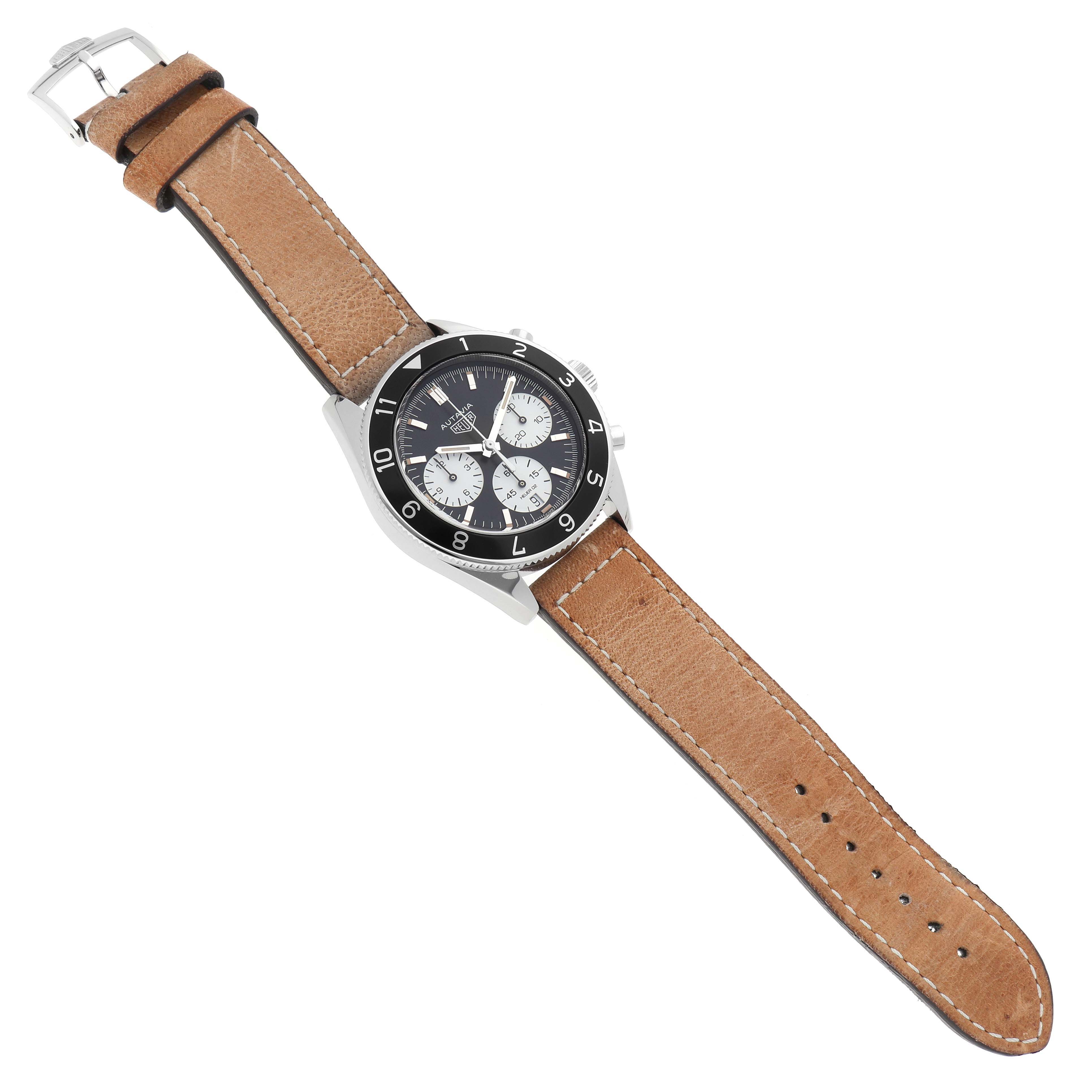 The Autavia model by Tag Heuer is shown from a top-down angle, displaying the watch face, bezel, case, and leather strap.