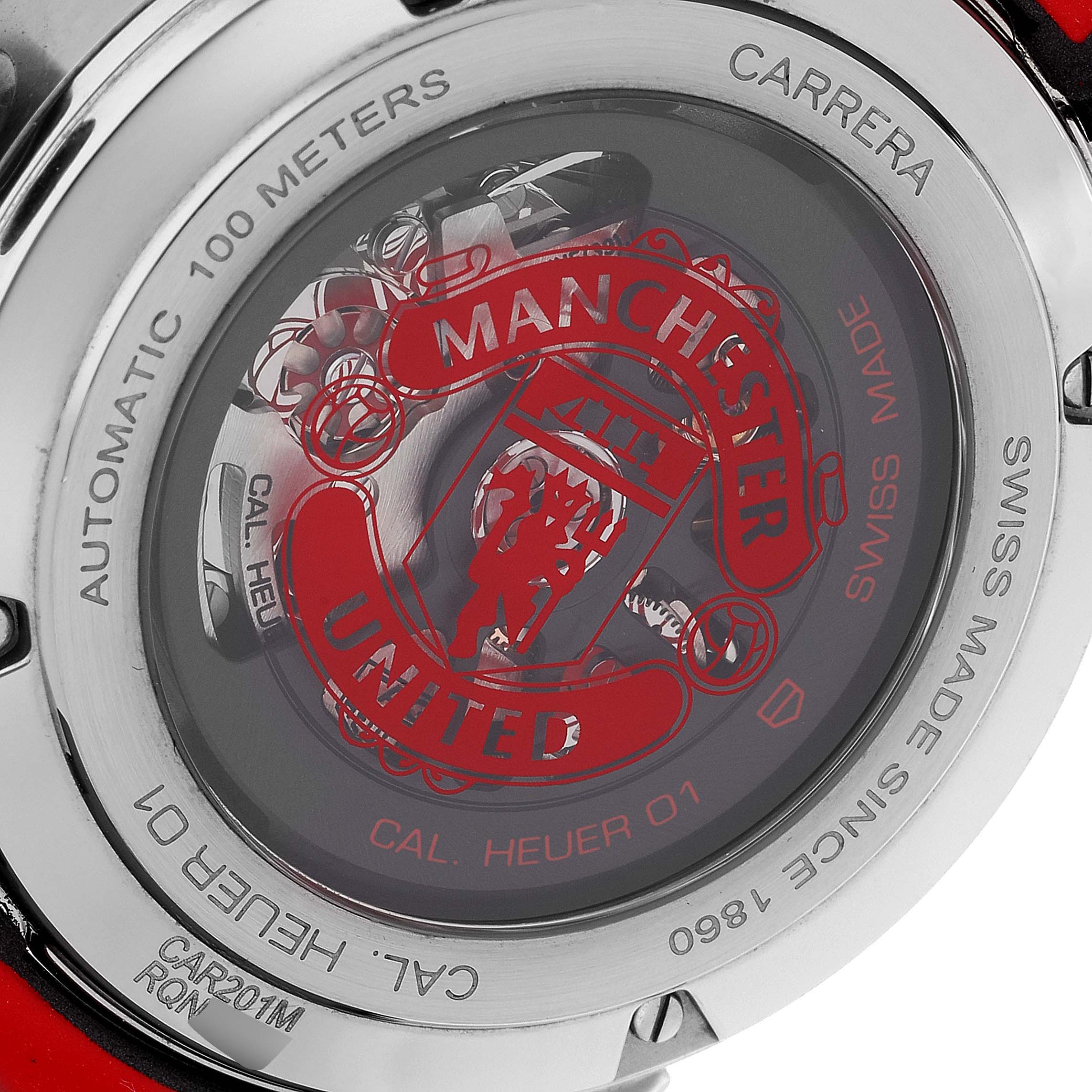 The image shows the back of a Tag Heuer Carrera CAR201M.FT6156 Men's Stainless Steel Silver Dial CAR201M.FT6156 Men's Stainless Steel Silver Dial watch, featuring the movement and Manchester United engraving.