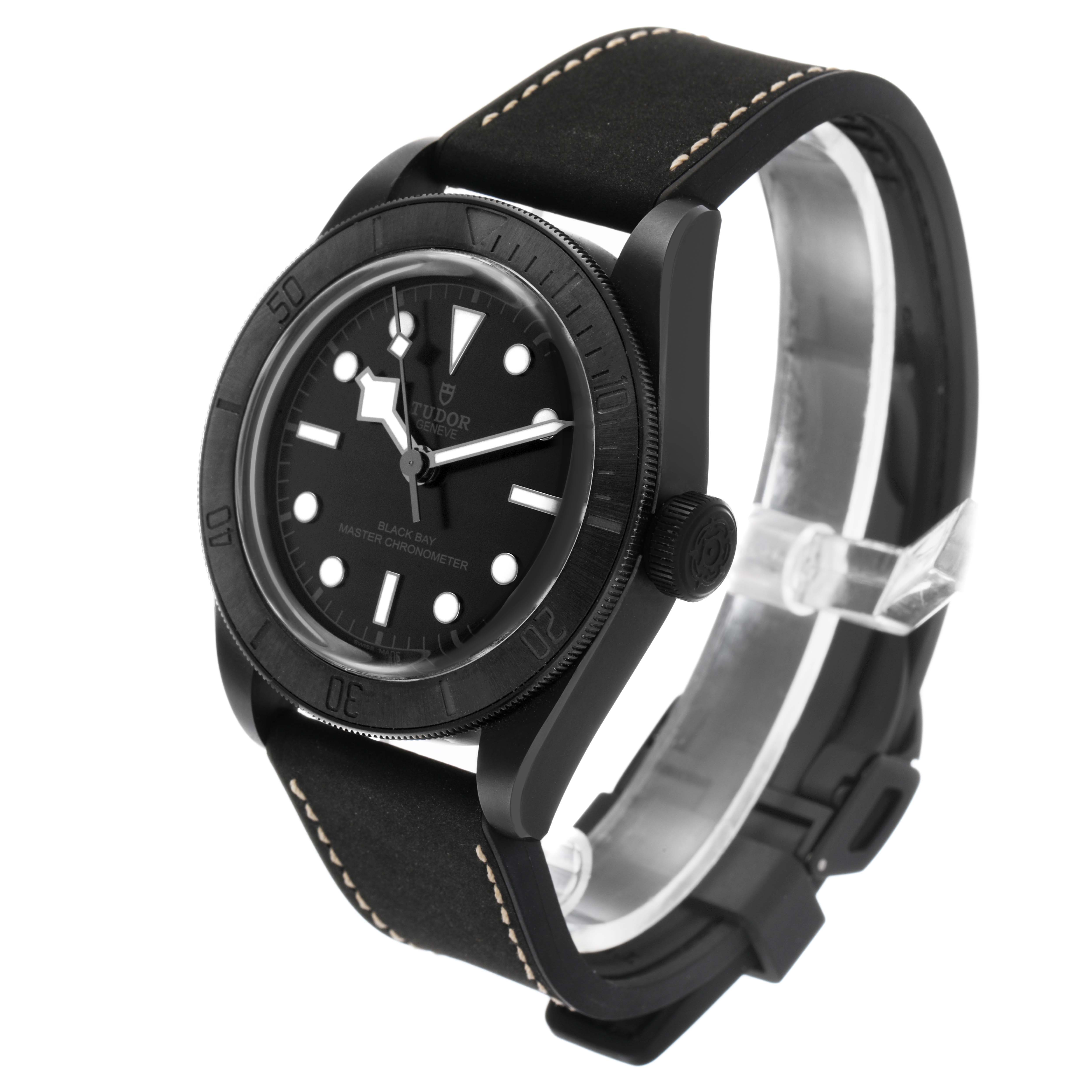 The Tudor Heritage Black Bay M79210CNU Men's Ceramic Black Dial watch is shown at an angled side view, highlighting the case, bezel, dial, and strap.