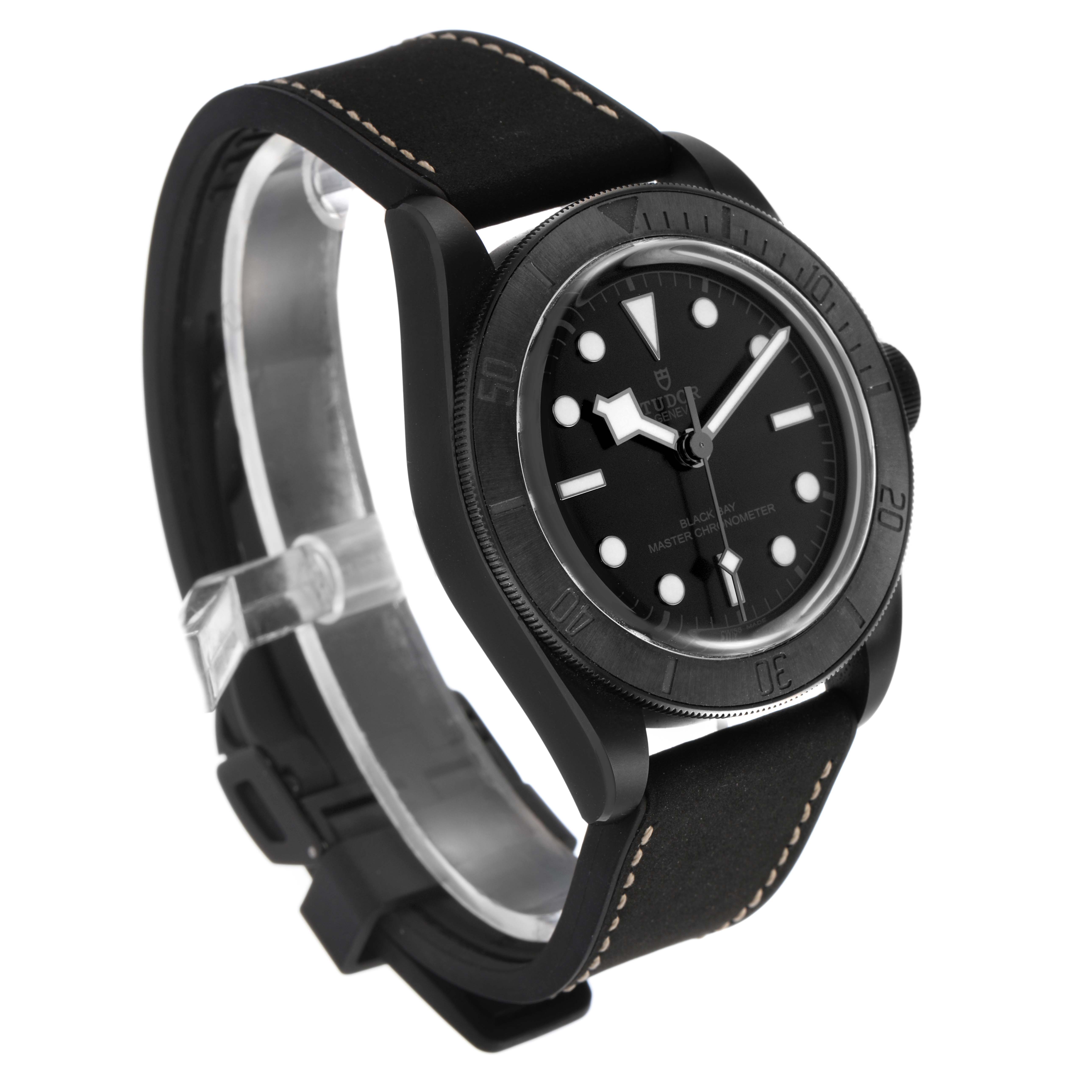 The Tudor Heritage Black Bay M79210CNU Men's Ceramic Black Dial watch is shown at a side angle, displaying the face, bezel, and strap with visible stitching.
