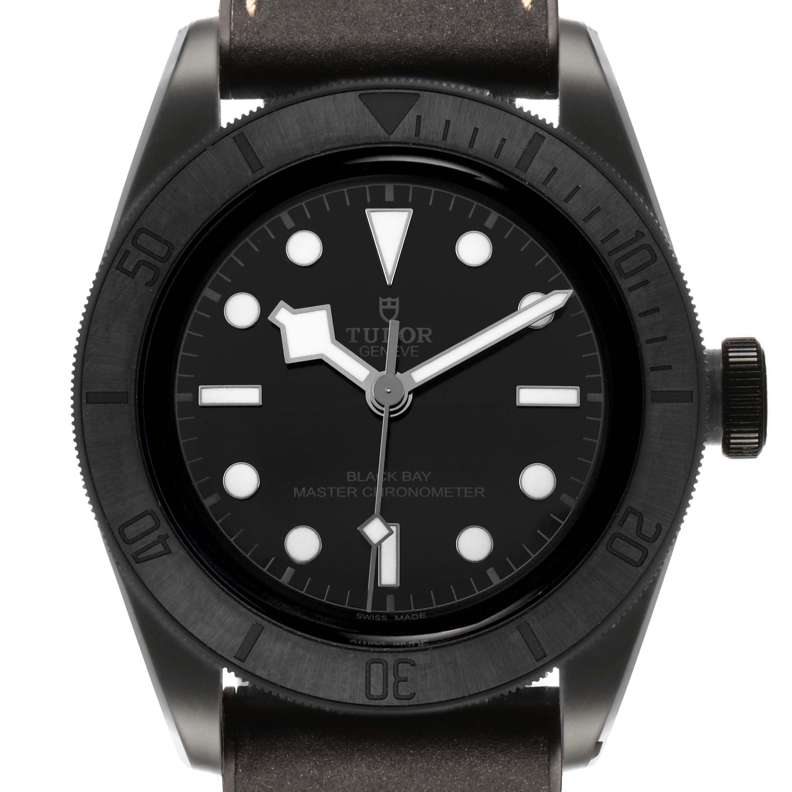 The image shows a front view of the Tudor Heritage Black Bay M79210CNU Men's Ceramic Black Dial watch, highlighting the dial, bezel, and part of the strap.