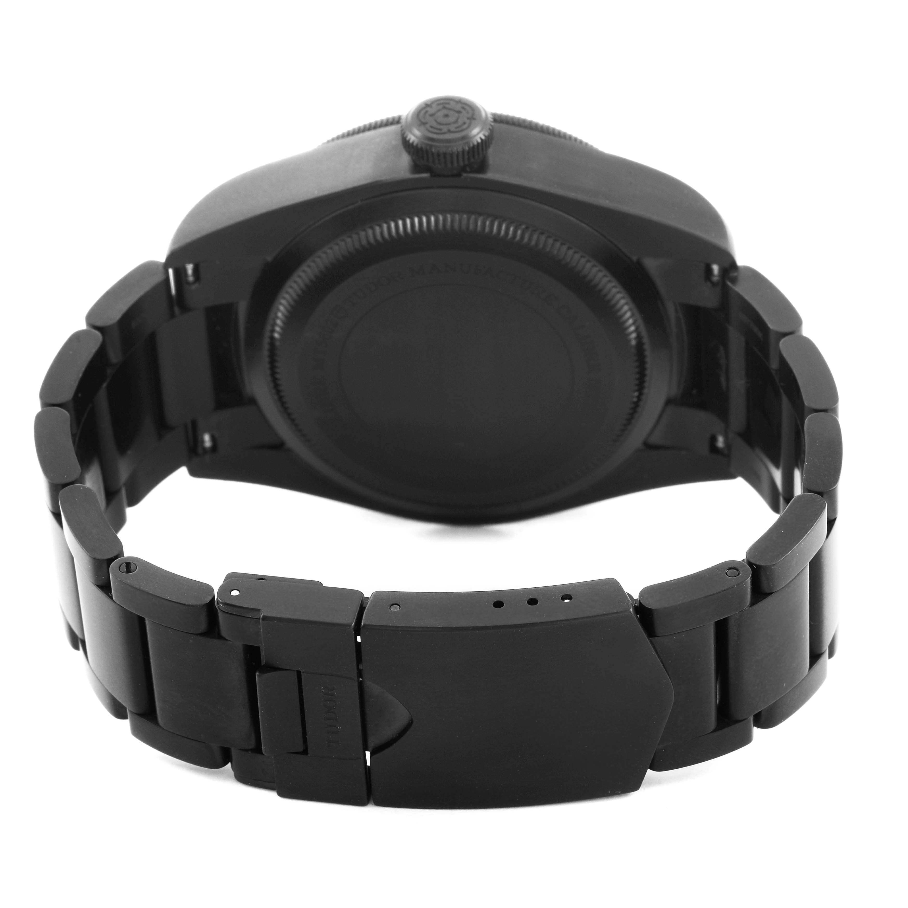 The image shows the back of the Tudor Heritage Black Bay 79230DK Men's Stainless Steel Black Dial watch, highlighting the case, crown, and bracelet clasp.