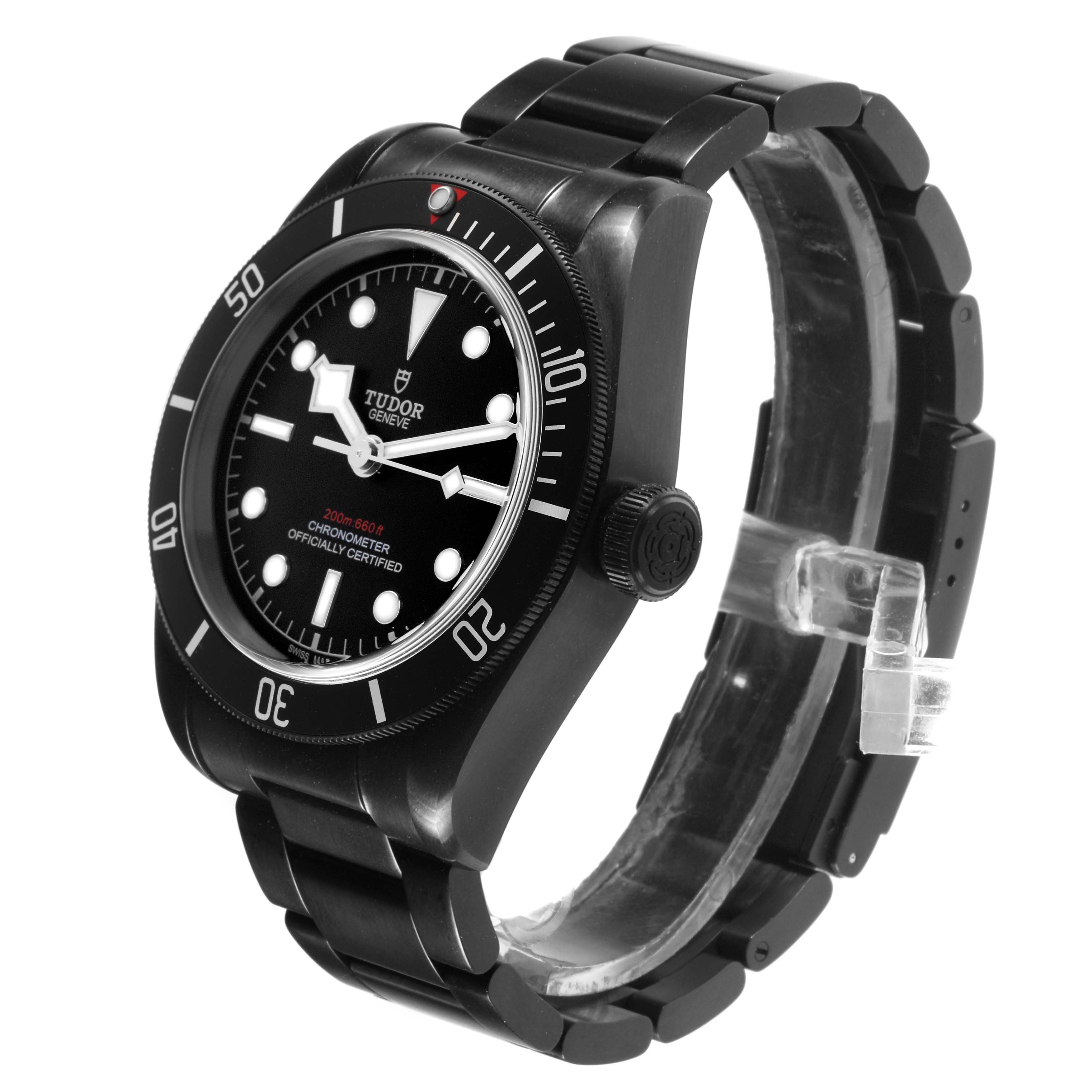 The Tudor Heritage Black Bay 79230DK Men's Stainless Steel Black Dial watch is shown at a three-quarter angle, displaying the dial, bezel, crown, and bracelet.