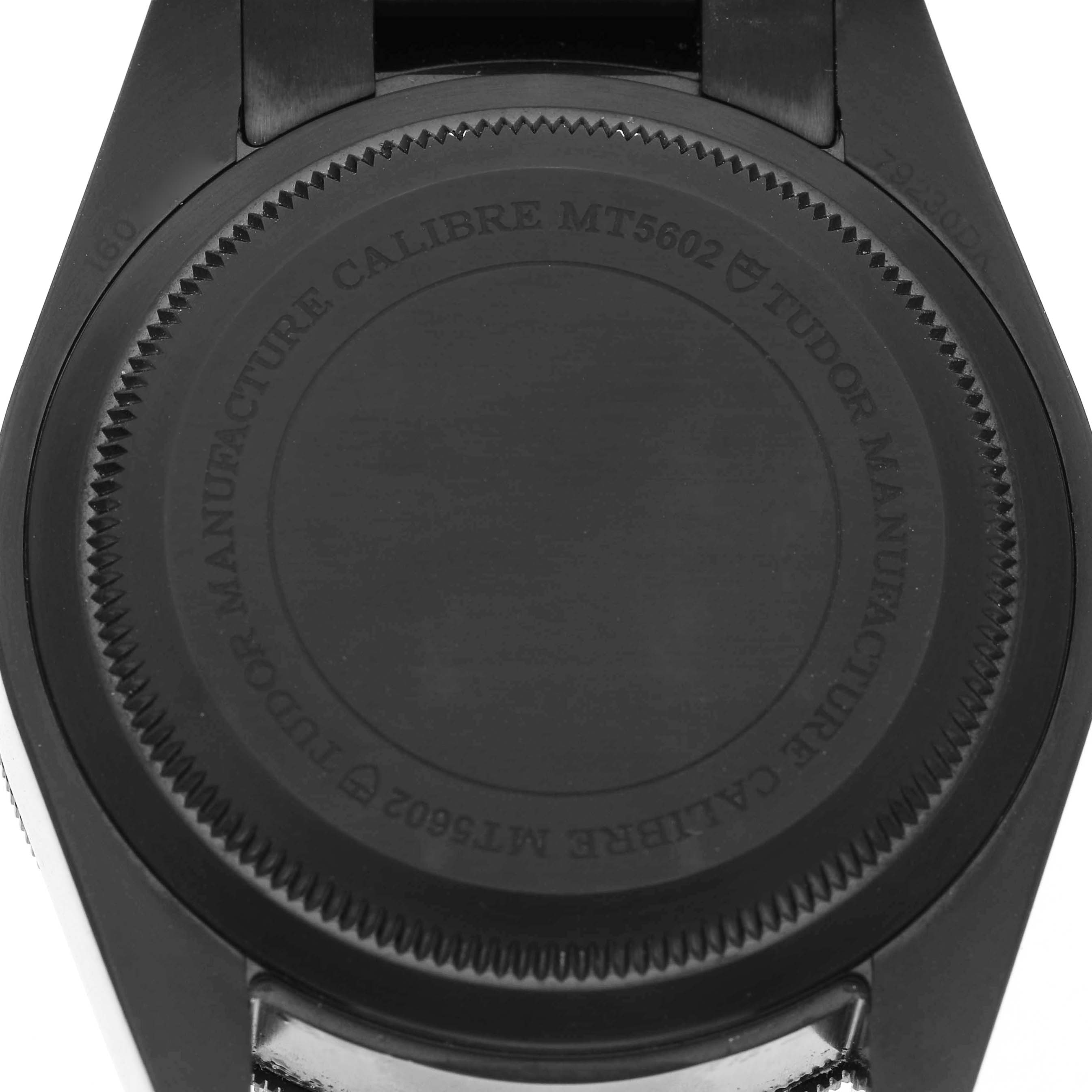 The image shows the case back of the Tudor Heritage Black Bay 79230DK Men's Stainless Steel Black Dial watch, highlighting the engraved text and design details.