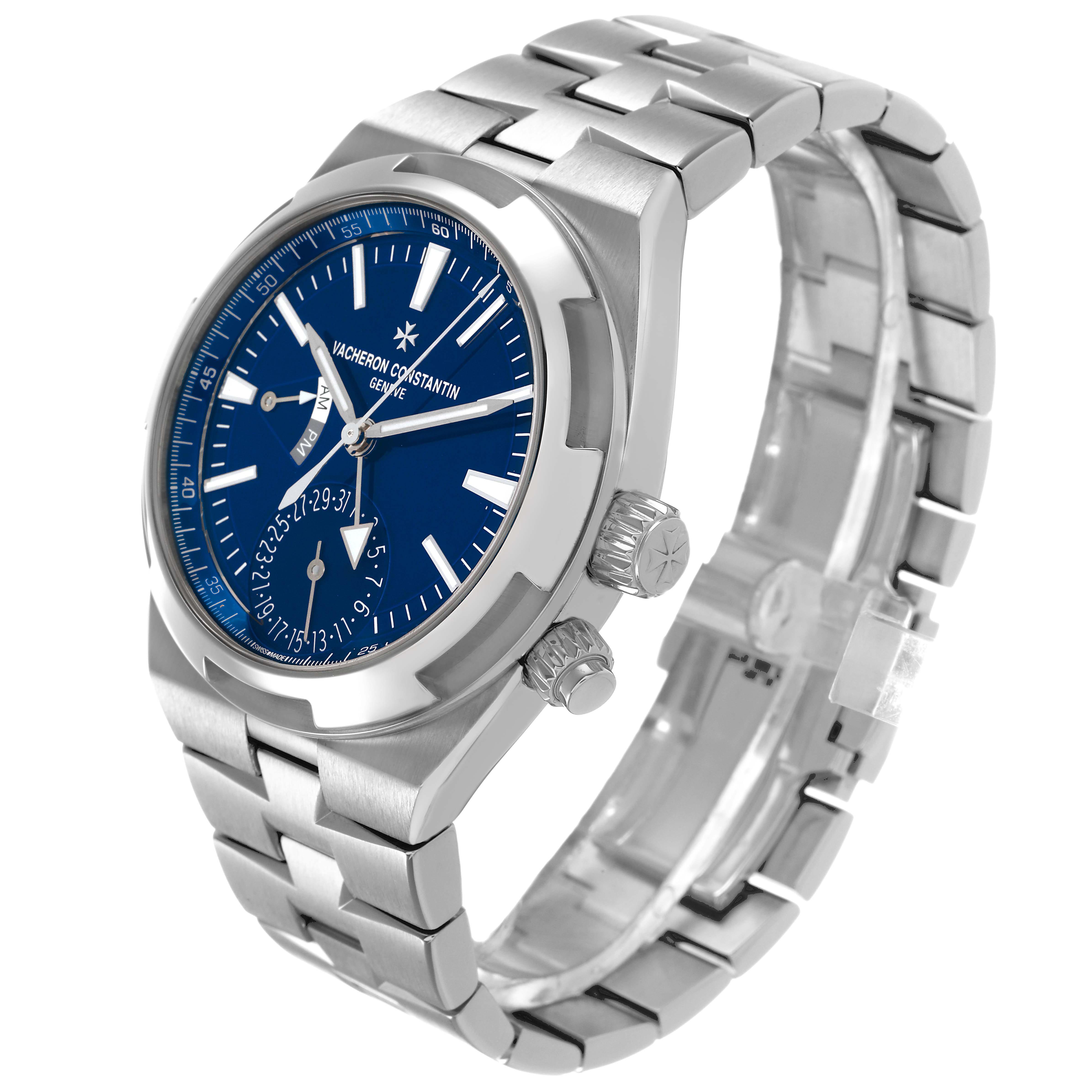 The Vacheron Constantin Overseas 7900V/110A-B334 Men's Stainless Steel Blue Dial watch is shown at a tilted angle, highlighting the blue dial, crown, and metal bracelet.
