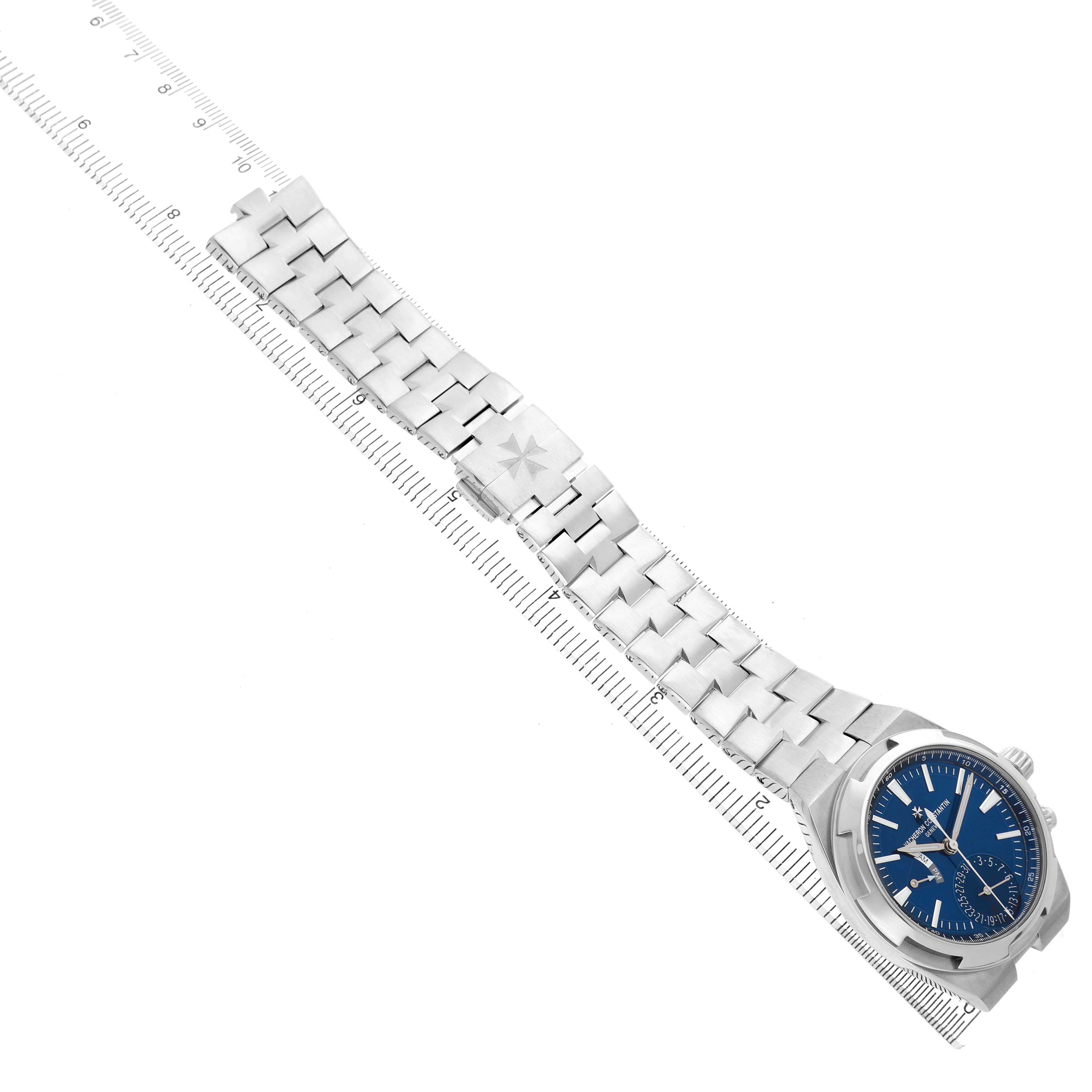The Vacheron Constantin Overseas 7900V/110A-B334 Men's Stainless Steel Blue Dial watch is shown from a top angle, displaying the bracelet, clasp, and blue dial.