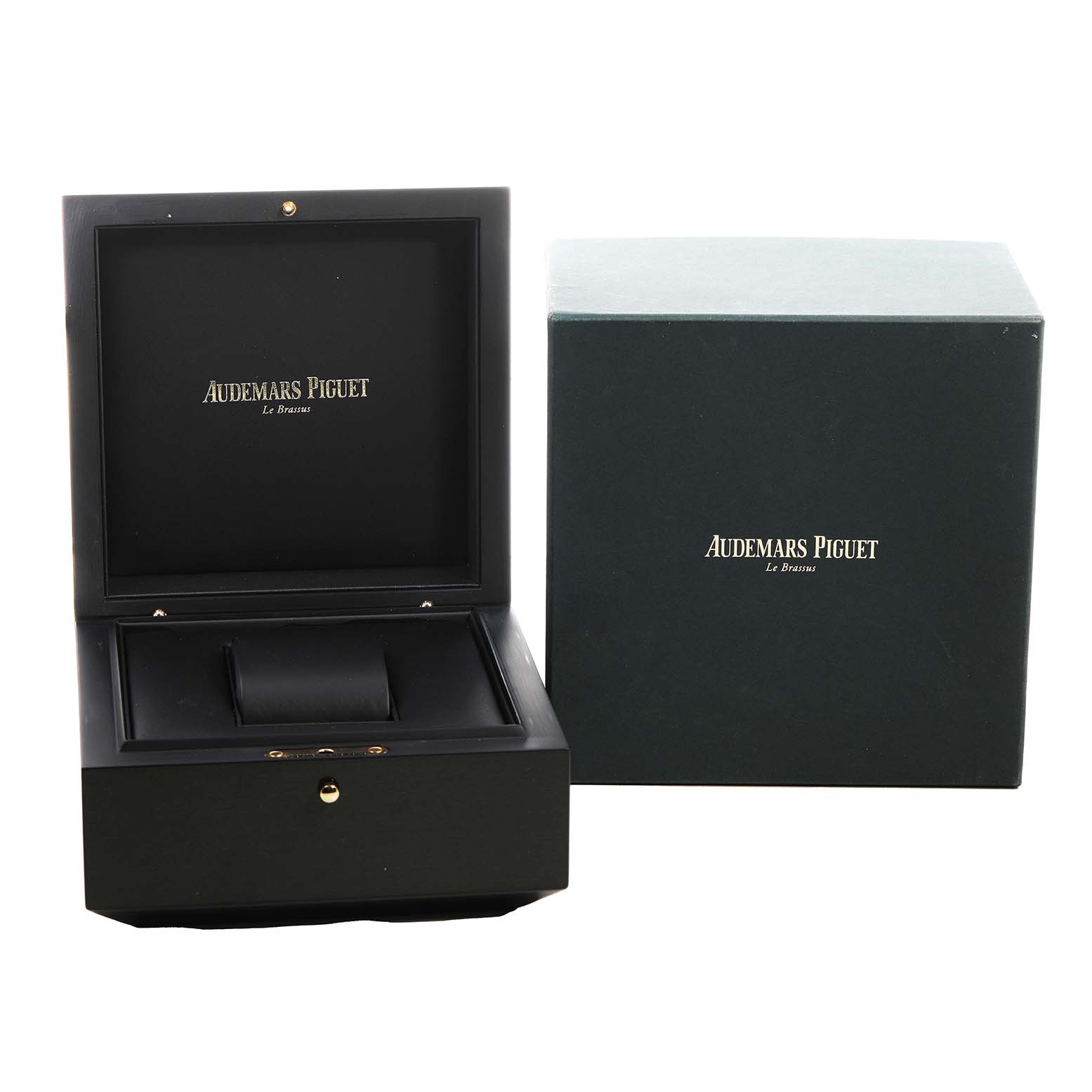 The image shows an opened Royal Oak Audemars Piguet watch box alongside a branded outer box.