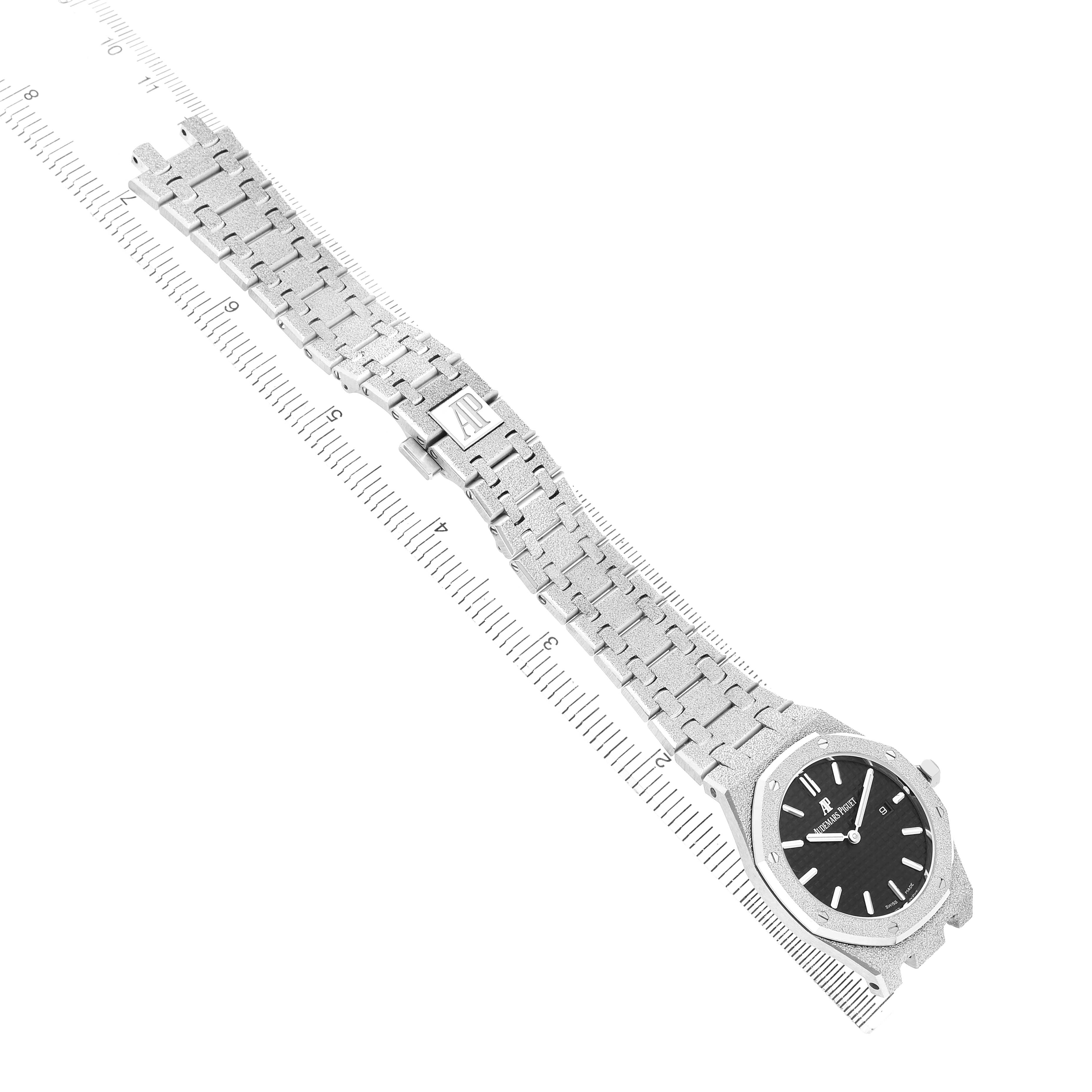 The Audemars Piguet Royal Oak 67653BC Women's White Gold Black Dial watch is shown diagonally, displaying its full bracelet and face.