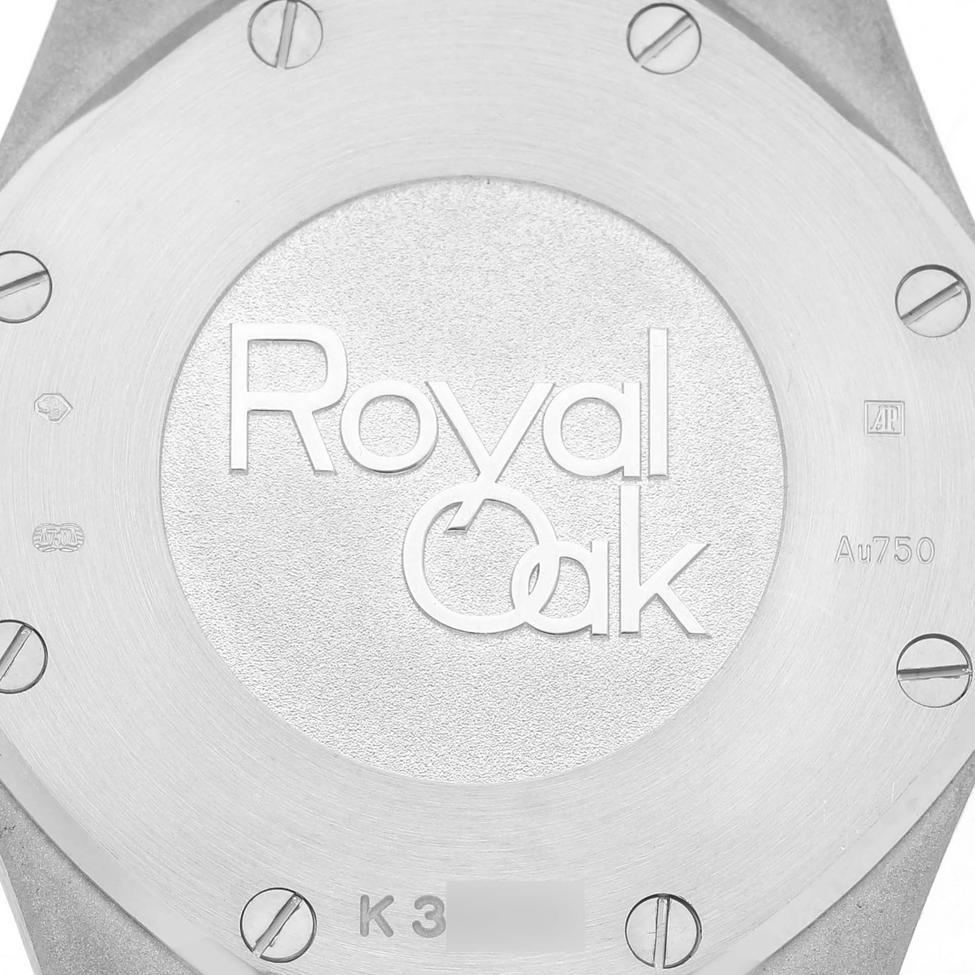 The image shows the back case of an Audemars Piguet Royal Oak 67653BC Women's White Gold Black Dial watch, highlighting the logo, screws, and engravings.