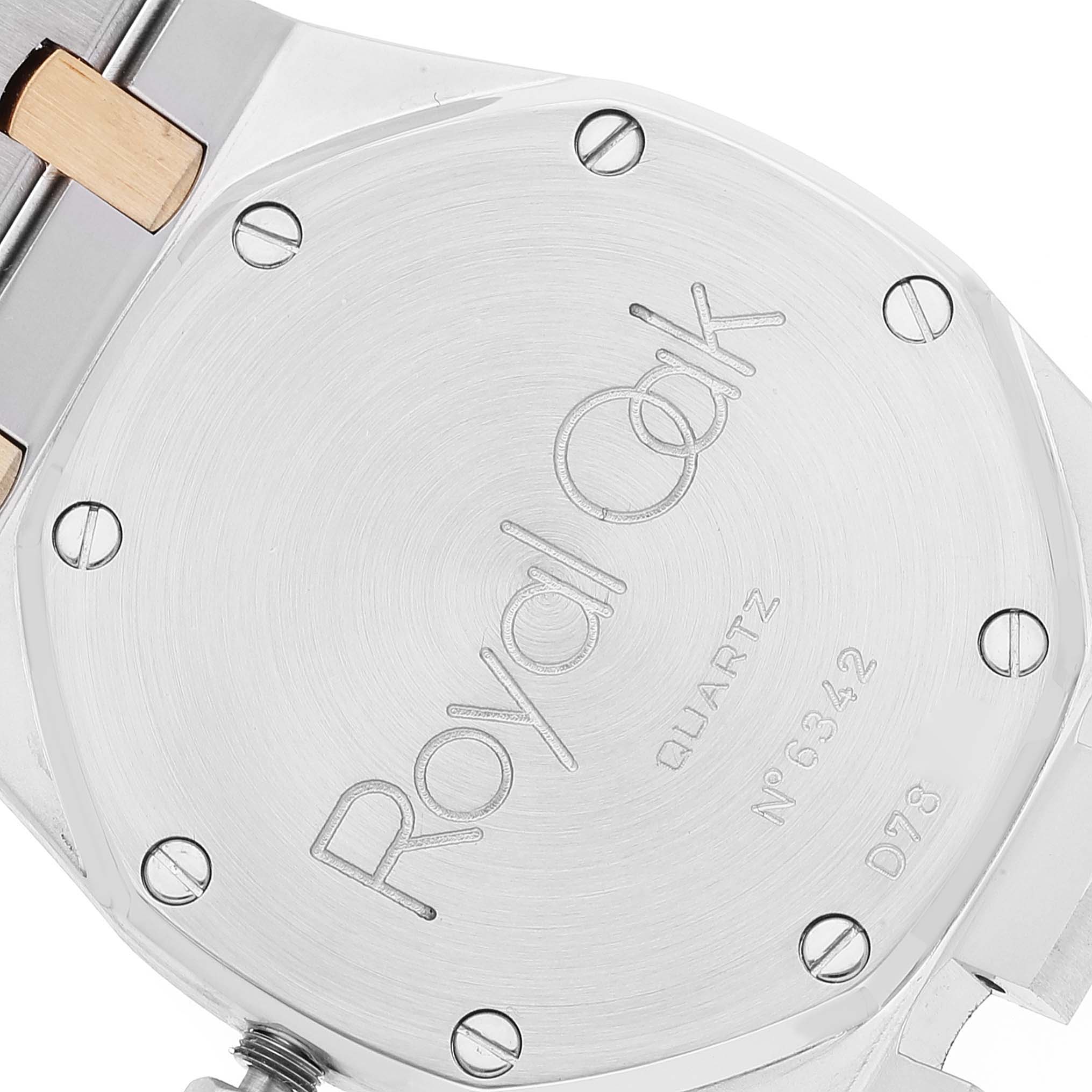 This image shows the case back of an Audemars Piguet Royal Oak 56303SA Men's Steel and Gold (two tone) Grey Dial 56303SA Men's Steel and Gold (two tone) Grey Dial watch at a slight angle, displaying model engravings.