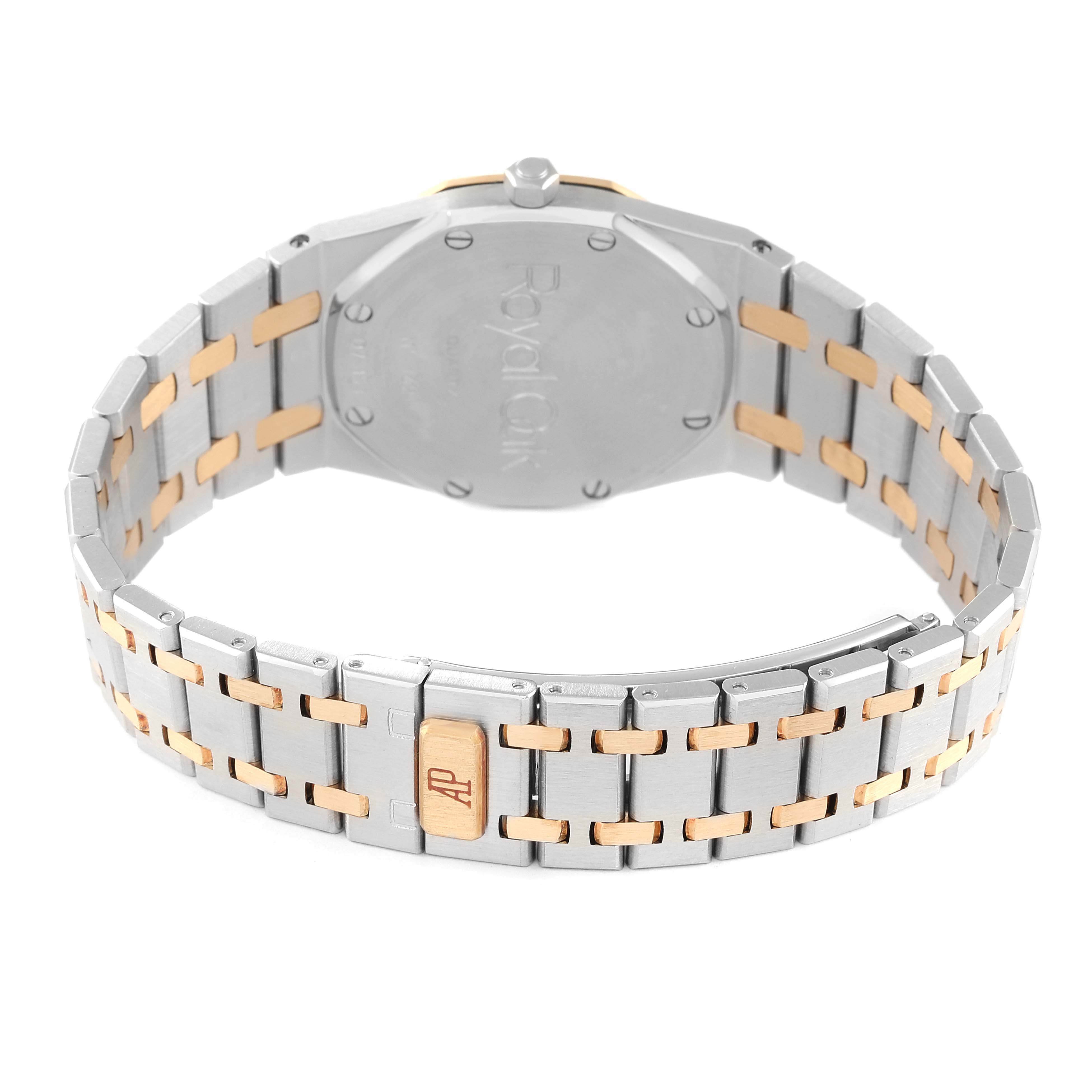 The image shows the back case and partly-open bracelet of a Royal Oak model by Audemars Piguet.