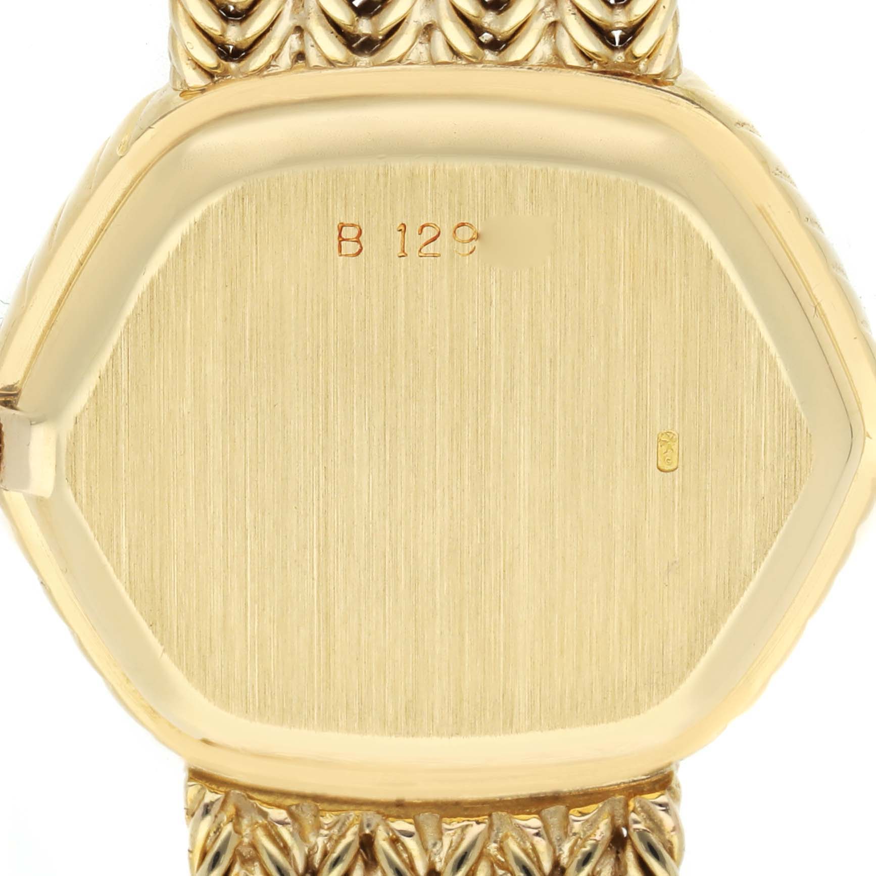 The image shows the back of a Vintage Audemars Piguet watch case, featuring a gold finish and engraved markings.