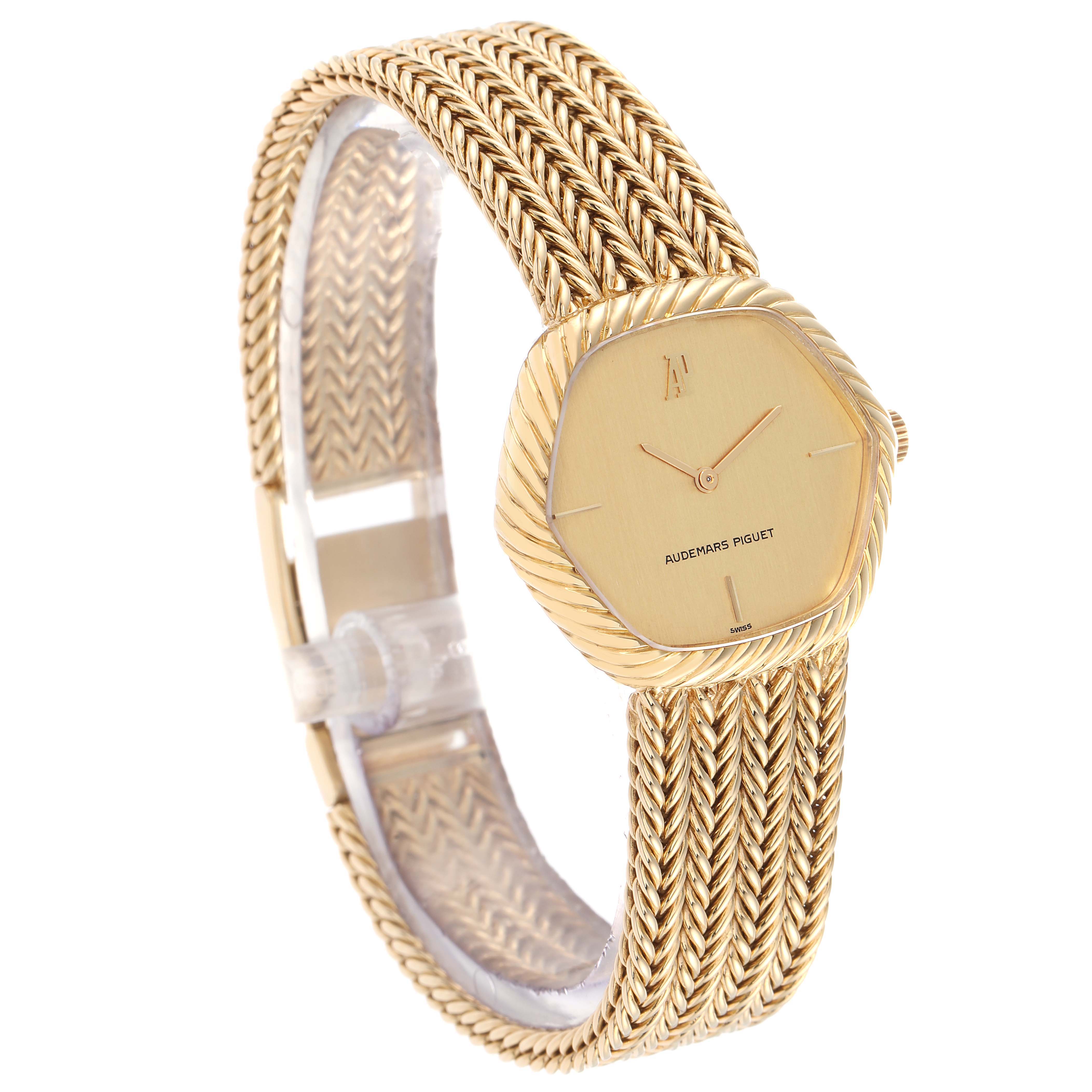 The vintage Audemars Piguet watch is shown at a three-quarter angle, highlighting the textured bezel, dial, and woven bracelet.