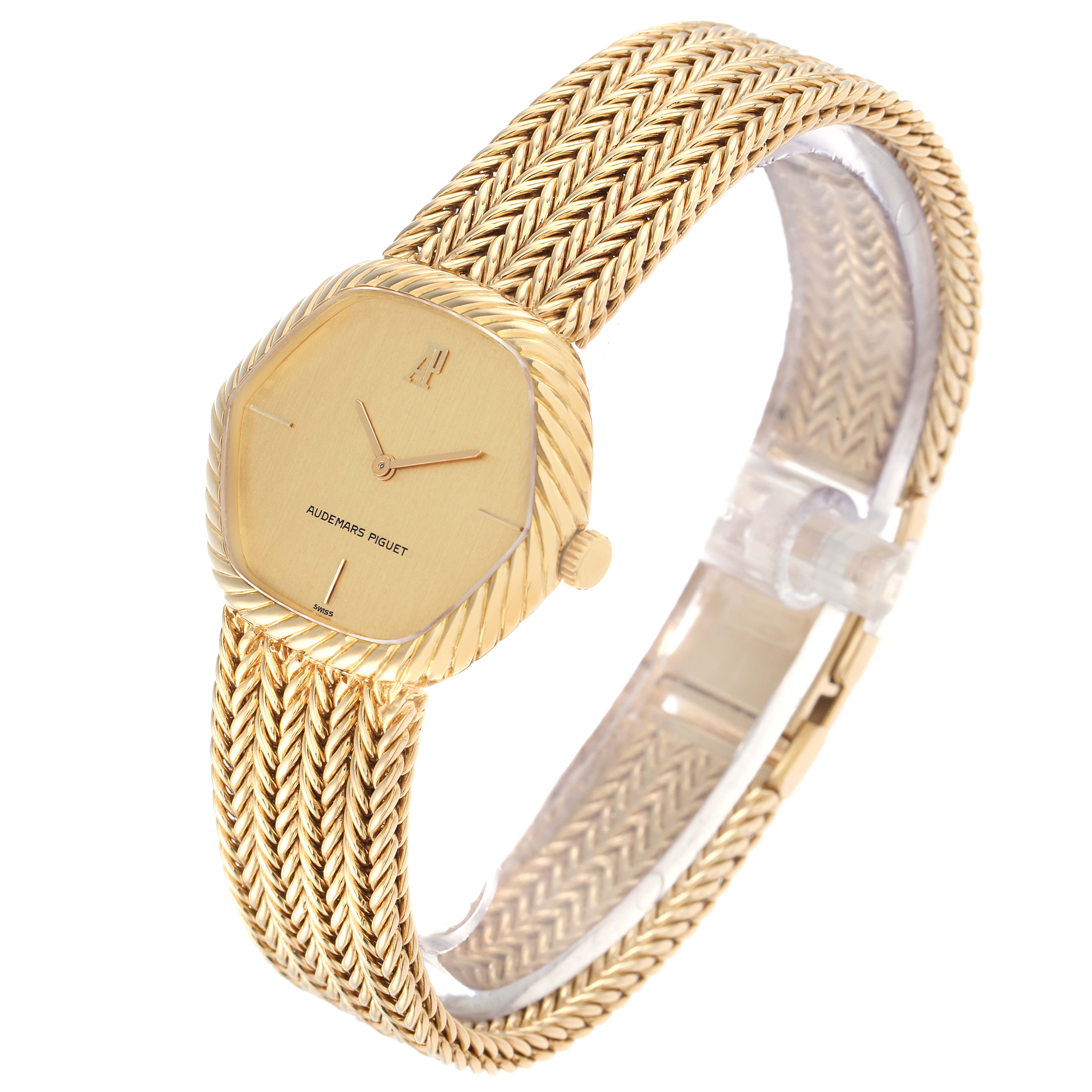 The Audemars Piguet Vintage Men
s Yellow Gold Champagne Dial watch is shown at an angled side view, highlighting the woven bracelet, dial, and crown.