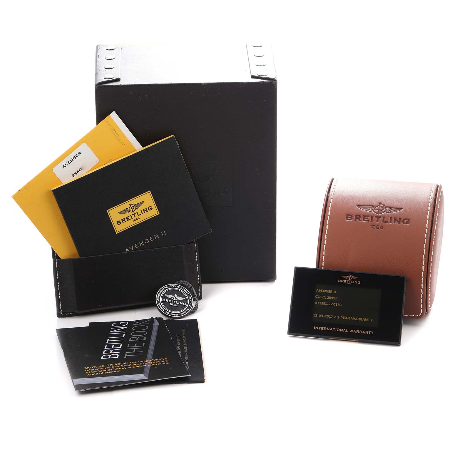 The image shows accessories for a Breitling Avenger A13381 Men
s Stainless Steel Blue Dial watch, including booklets, a warranty card, a box, and a leather case.