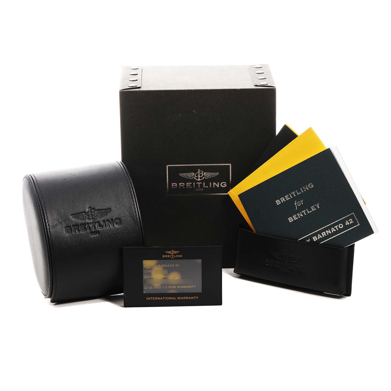 The image shows a Breitling for Bentley watch box, leather case, warranty card, and manuals from a front angle.